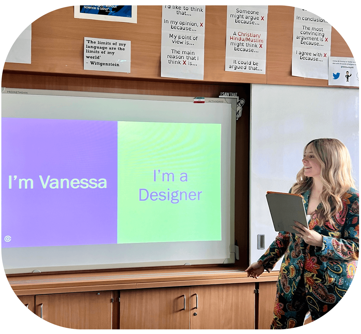 photo of someone presenting in front of a screen that says'vanessa' and 'I'm a designer'