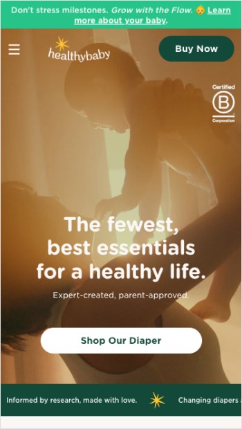 A person walks down a snow-covered street with parked cars.