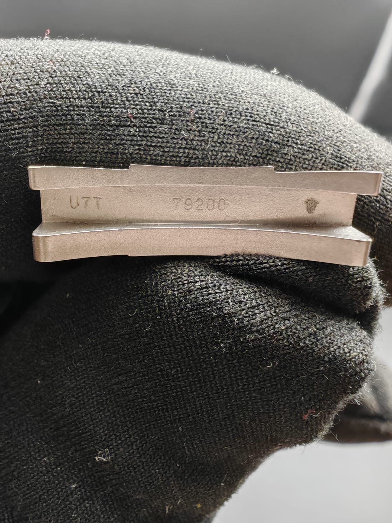 a close up of a watch on a black surface