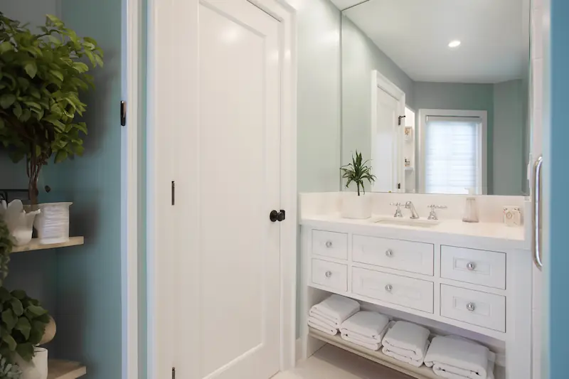 Tranquil guest bathroom with built-in shelveing and custom vanity from the Big Canyon Remodel project. Photo by Chris Darnall.