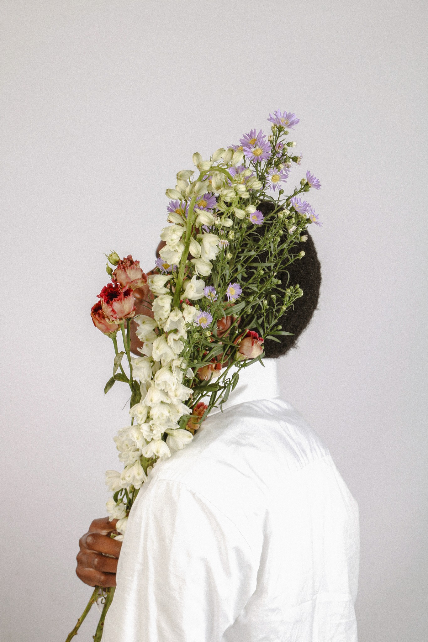 Boy covered by flowers