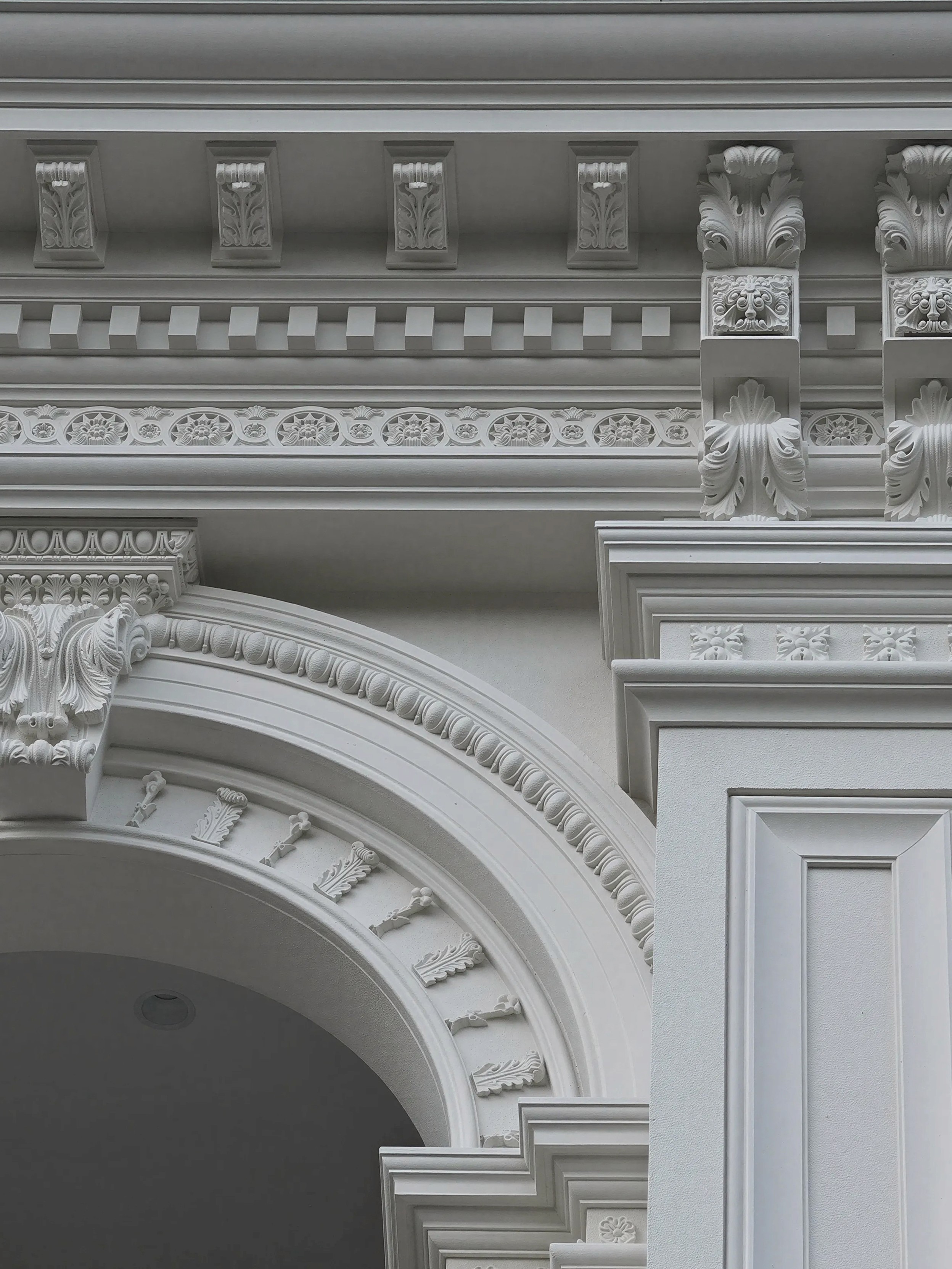 Detailed classical facade mouldings and arched entry at Afton
