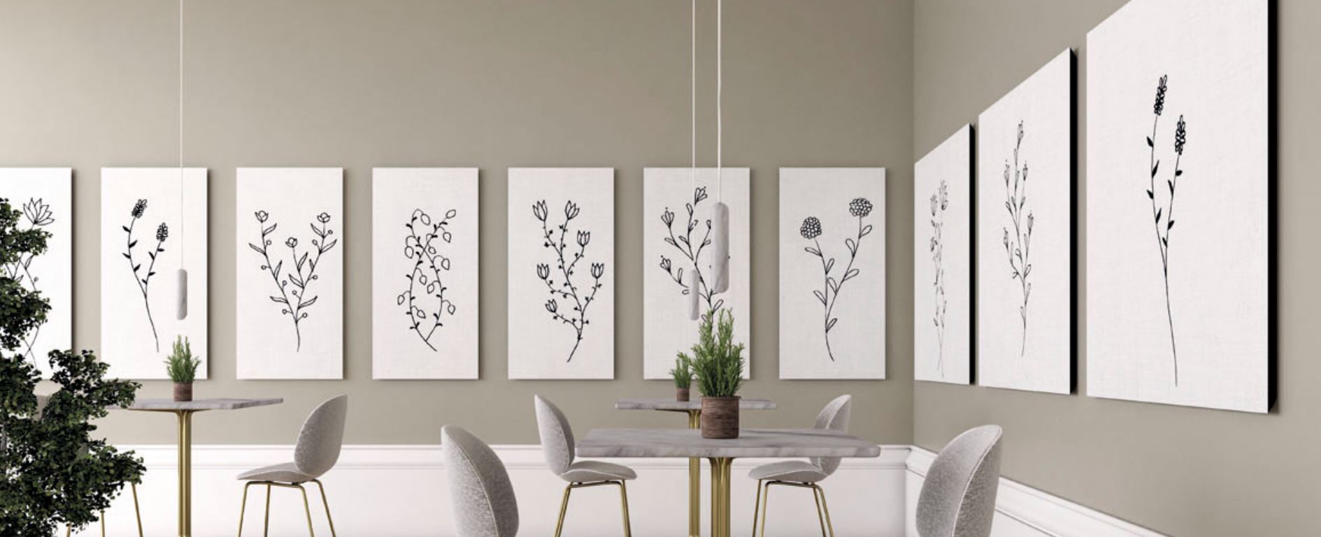 Botanical line art canvases adorn a minimalist cafe wall.