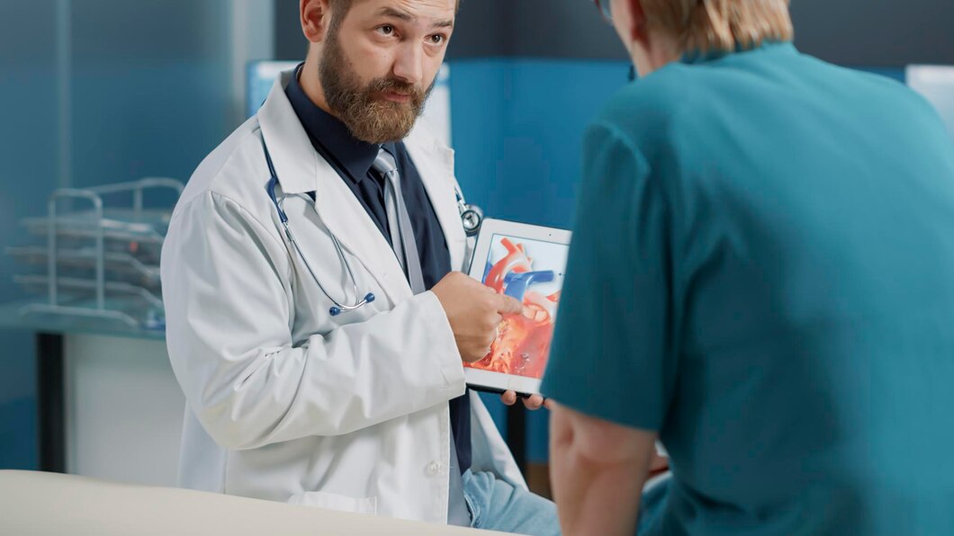 A doctor explaining anatomy to the nurse for better understanding.