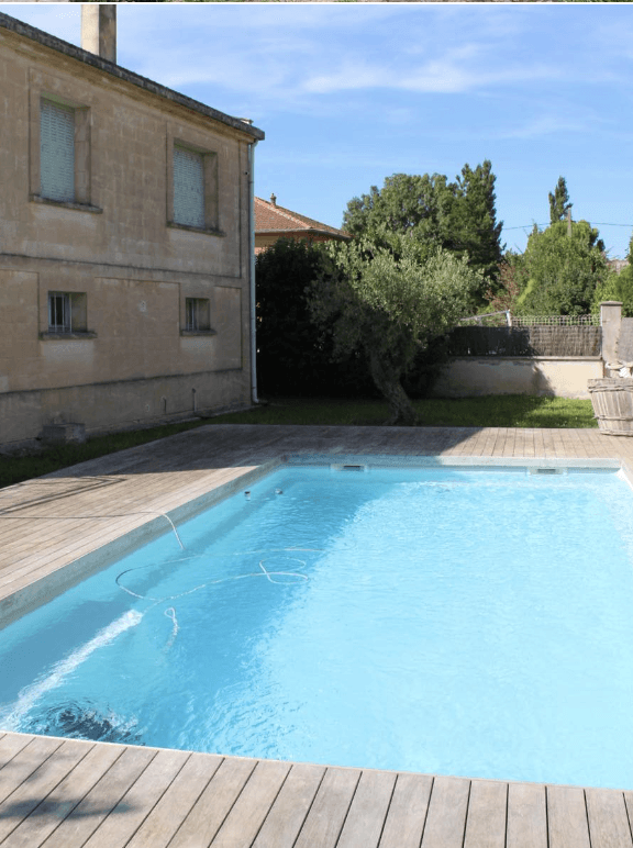 brown wooden house near green trees during daytime