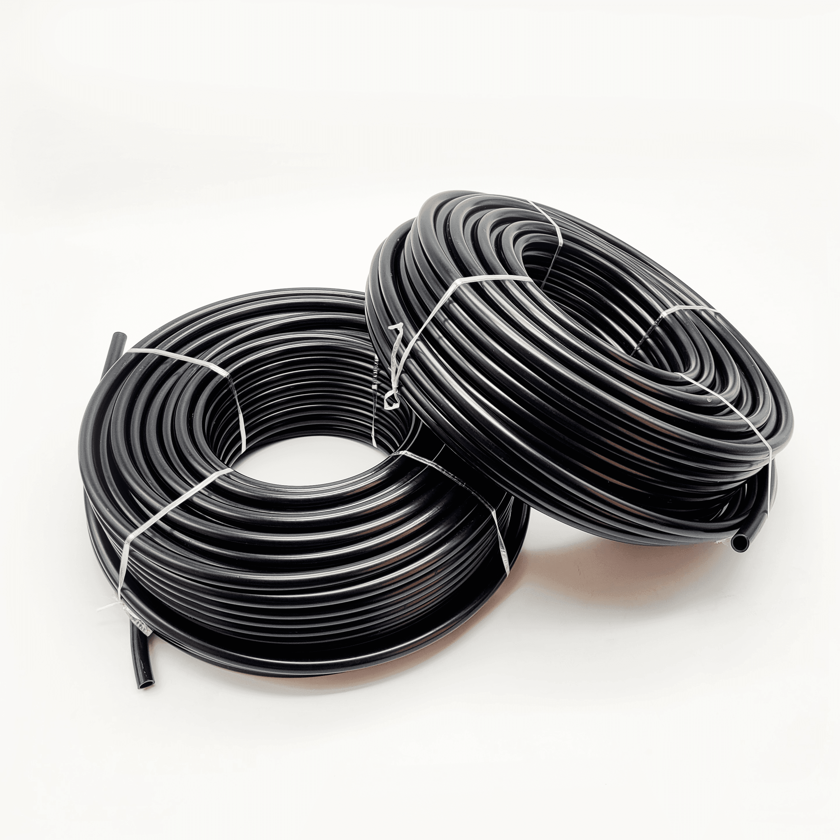 2 Rolls of Black color nylon Tube. One roll overlaps over other. 