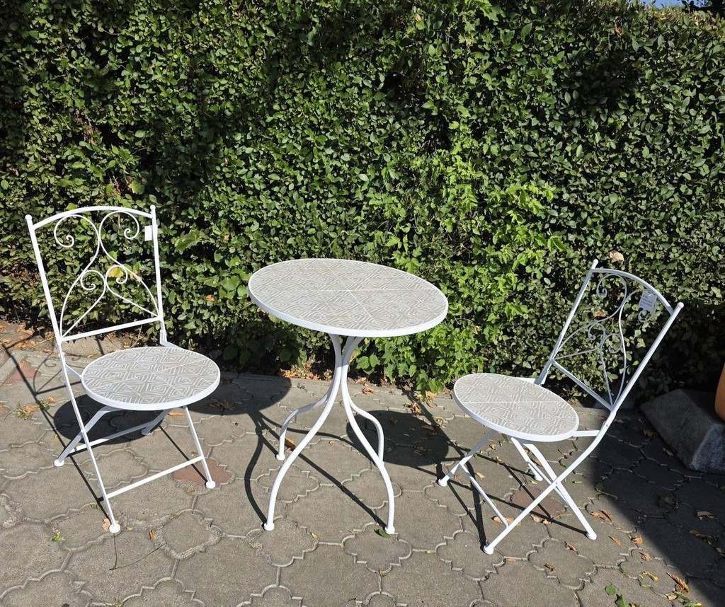 a group of people sitting at a table with a fire in the background
