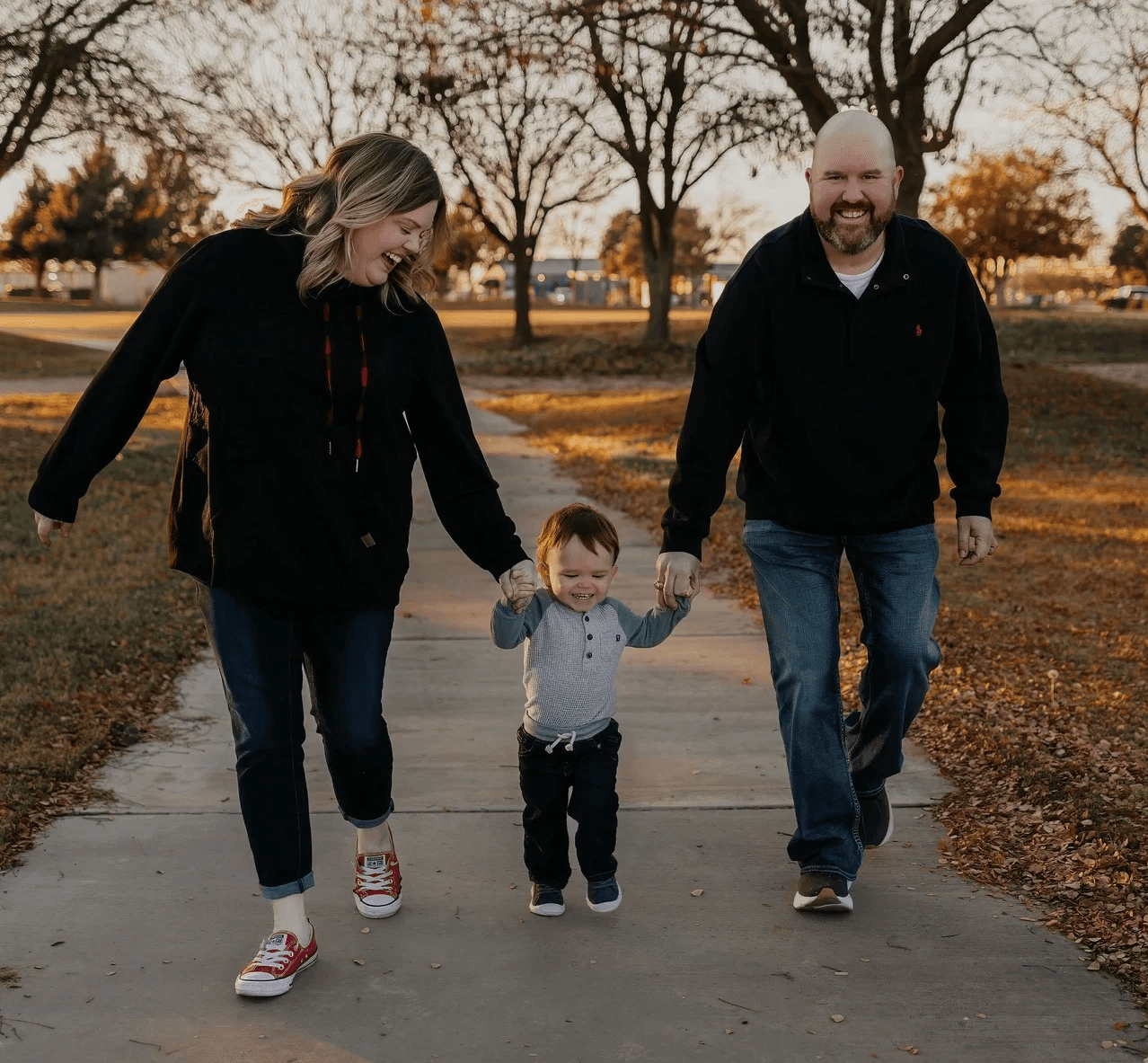 A family walks with their kid.