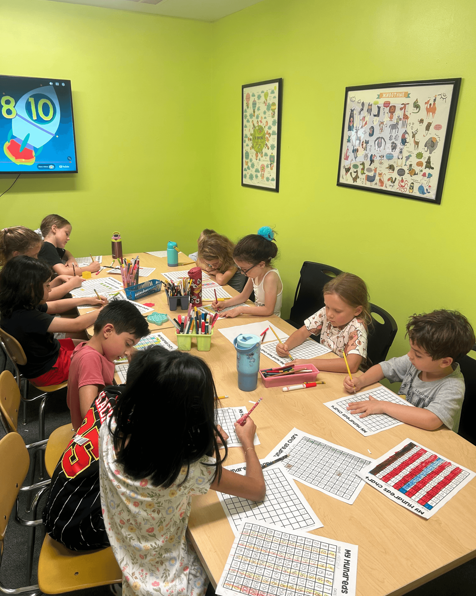 Children in a teacher-led classroom enrichment activity at SportPlus Academy
