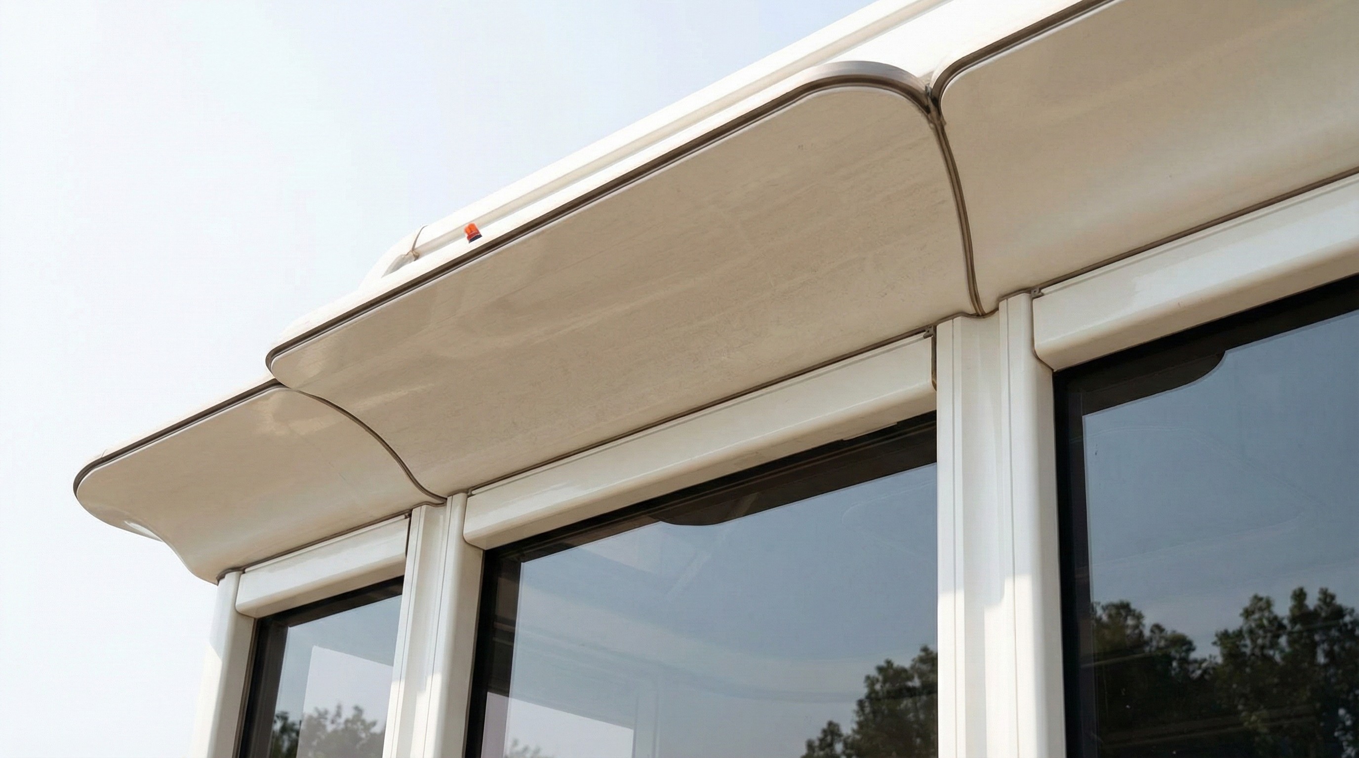 Close-up of custom-carved white marble cornice and facade panels by NOVA STONE on a luxury building.