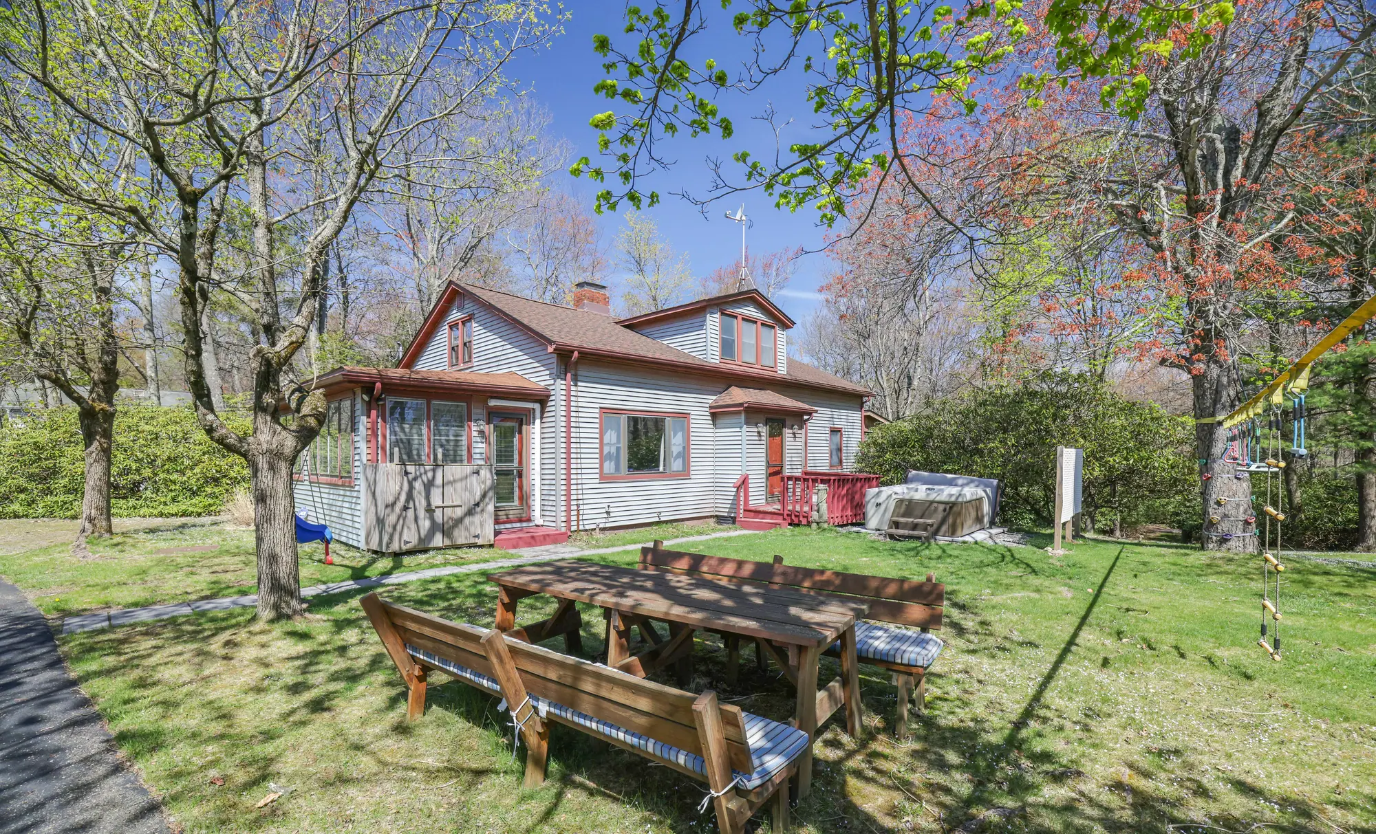 Long picnic table on the lawn behind the cottage at DeerPath Crossing, Lake Harmony, PA