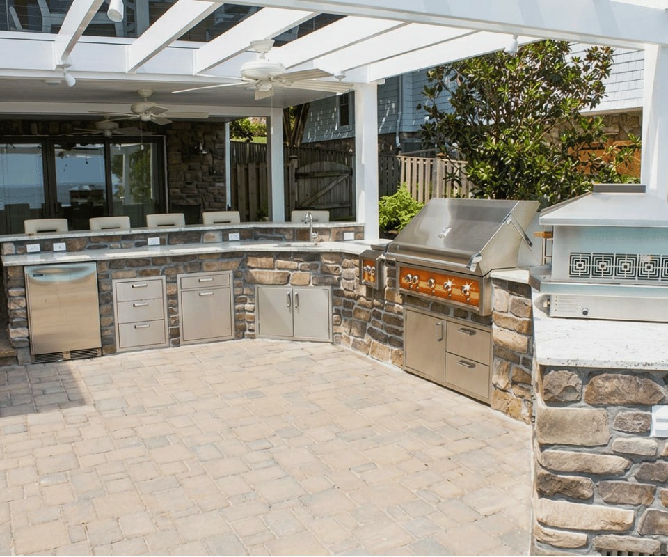 Entertaining Space Custom outdoor kitchen addition with stone base, built-in grill, countertop, and outdoor entertaining space