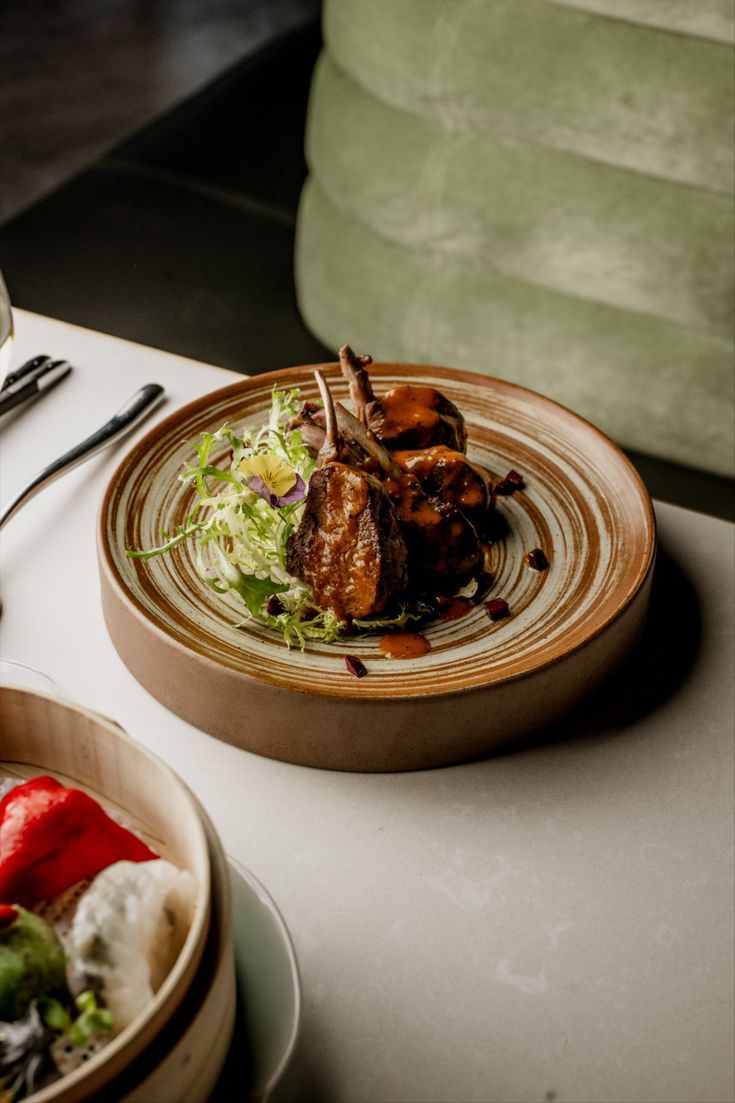 Elegant lamb chops served with Indian microgreens and spice-forward sauce, reflecting Dhoom’s dedication to ingredients that carry cultural meaning and culinary heritage.