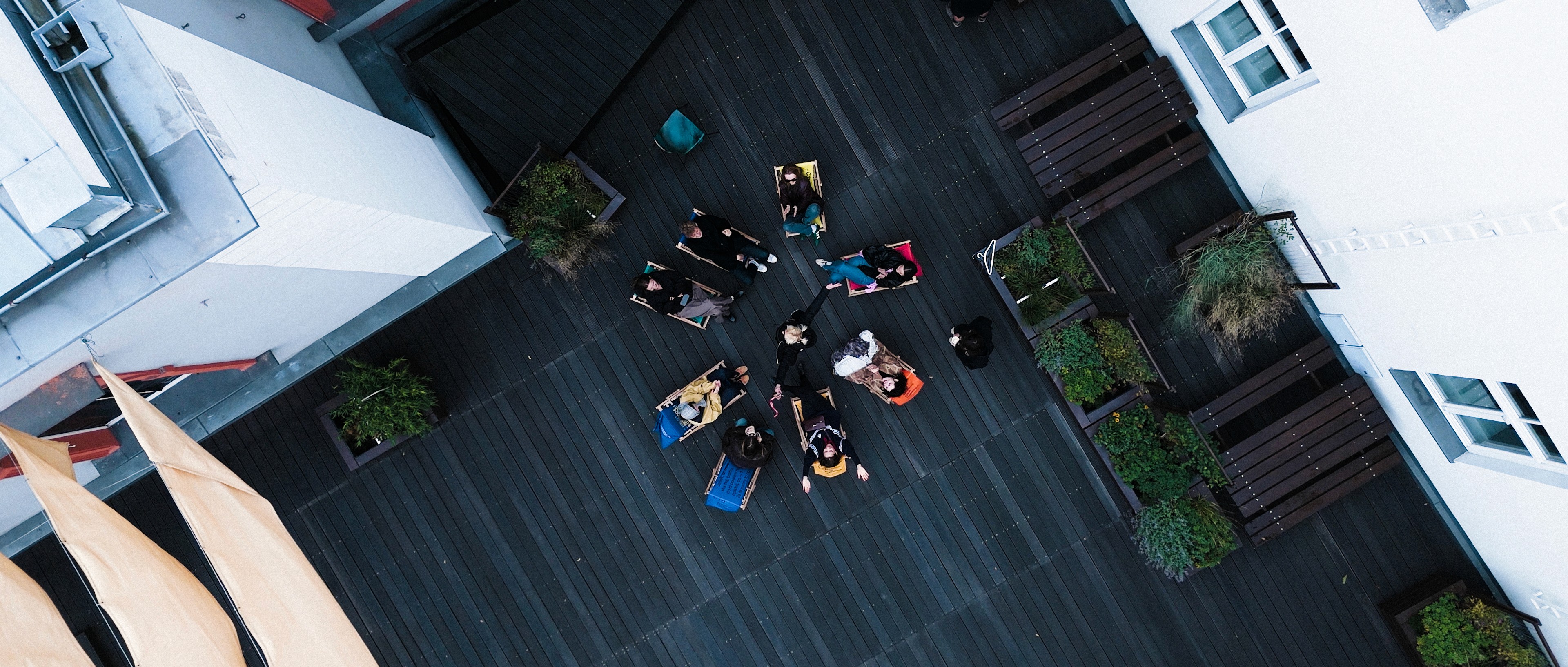 Overhead camera shot of a group of actors standing on a patterned carpet.