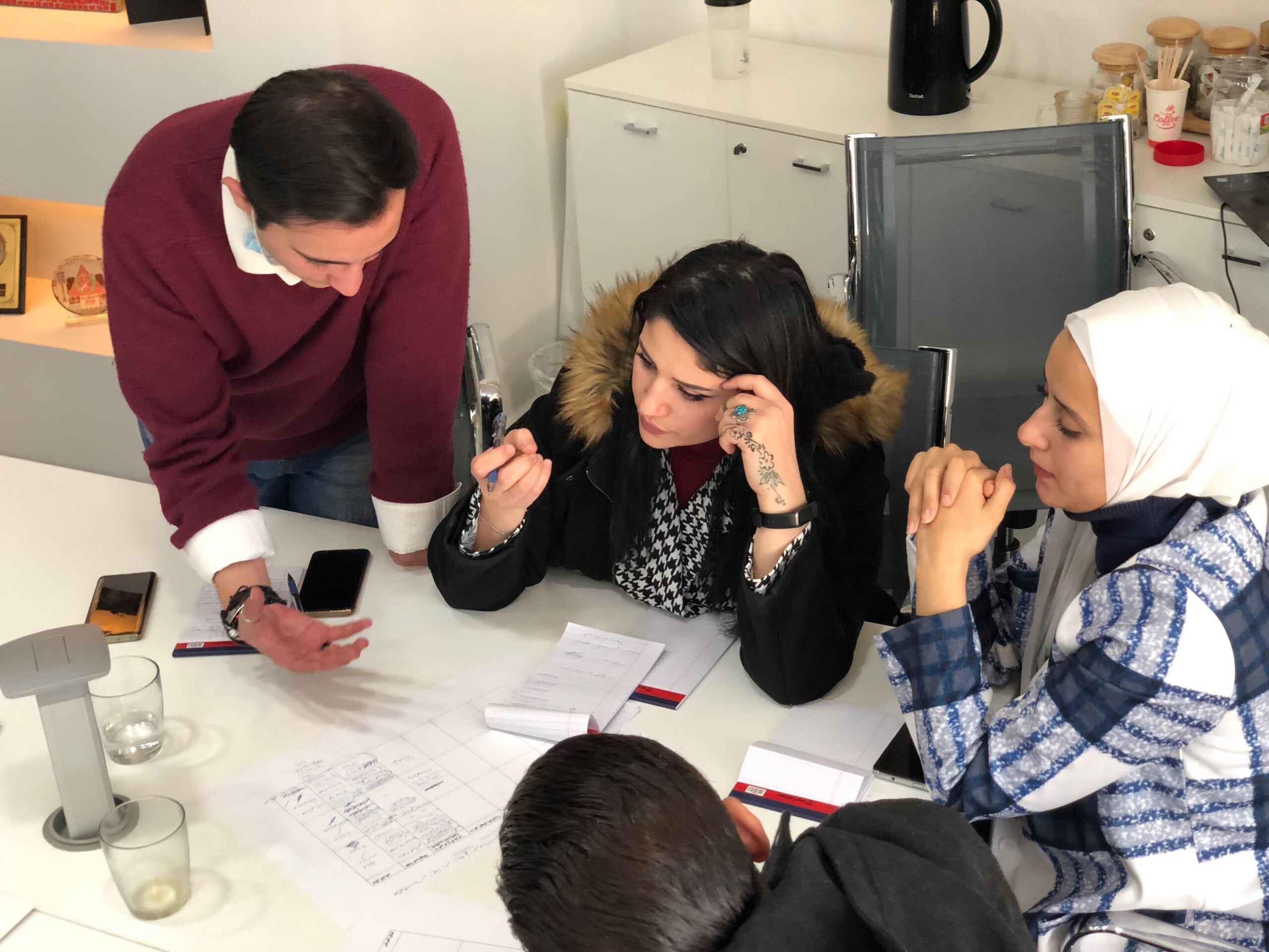 Community researchers working together around a table