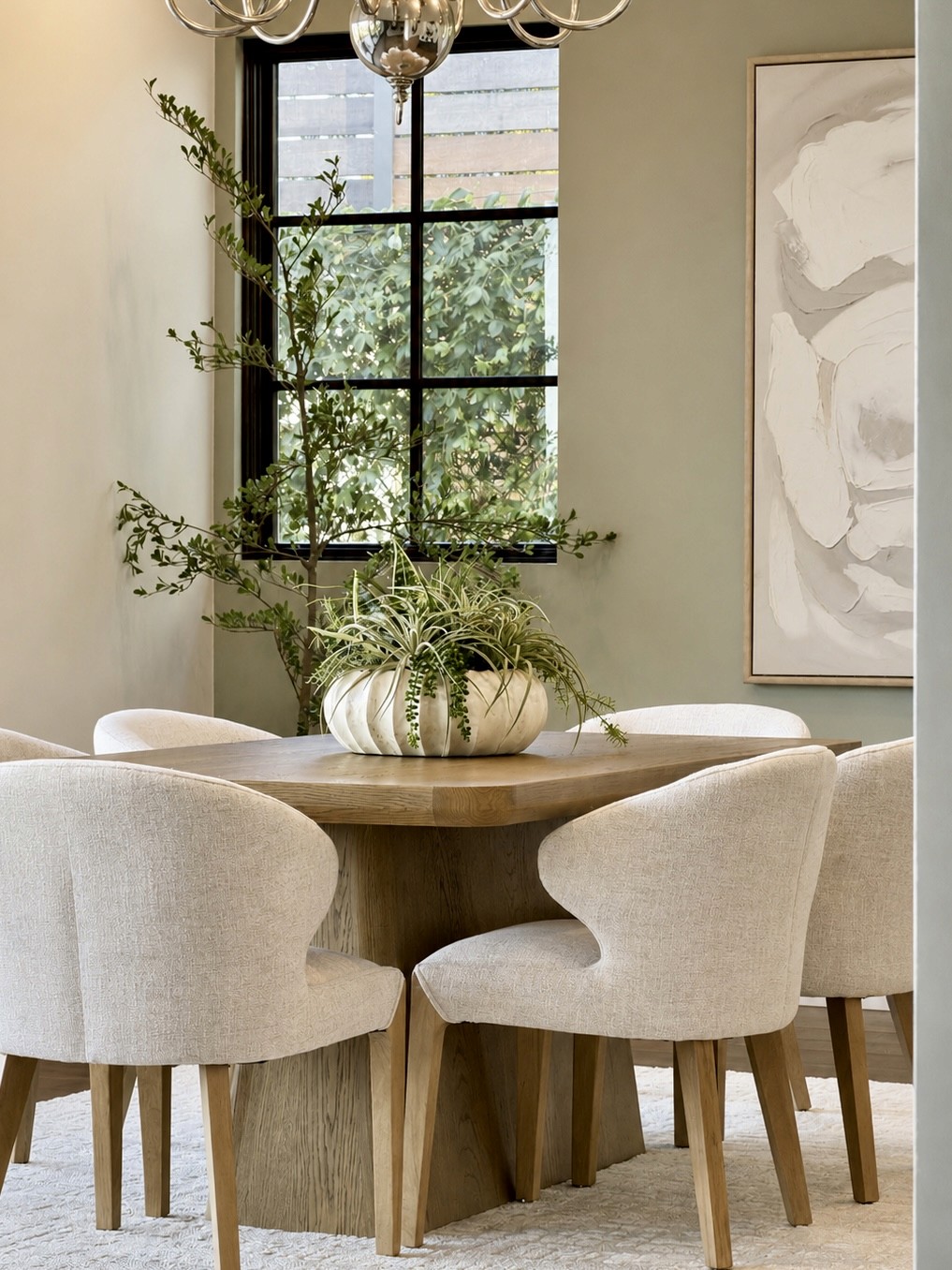 Professionally staged dining area with a wood table and cream chairs