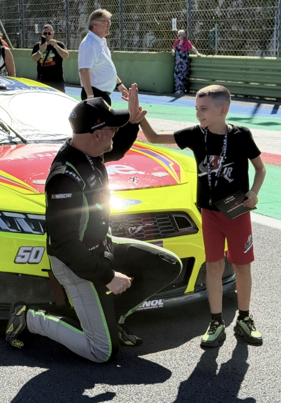 Henrik Peters sharing a high five with a young fan at Vallelunga