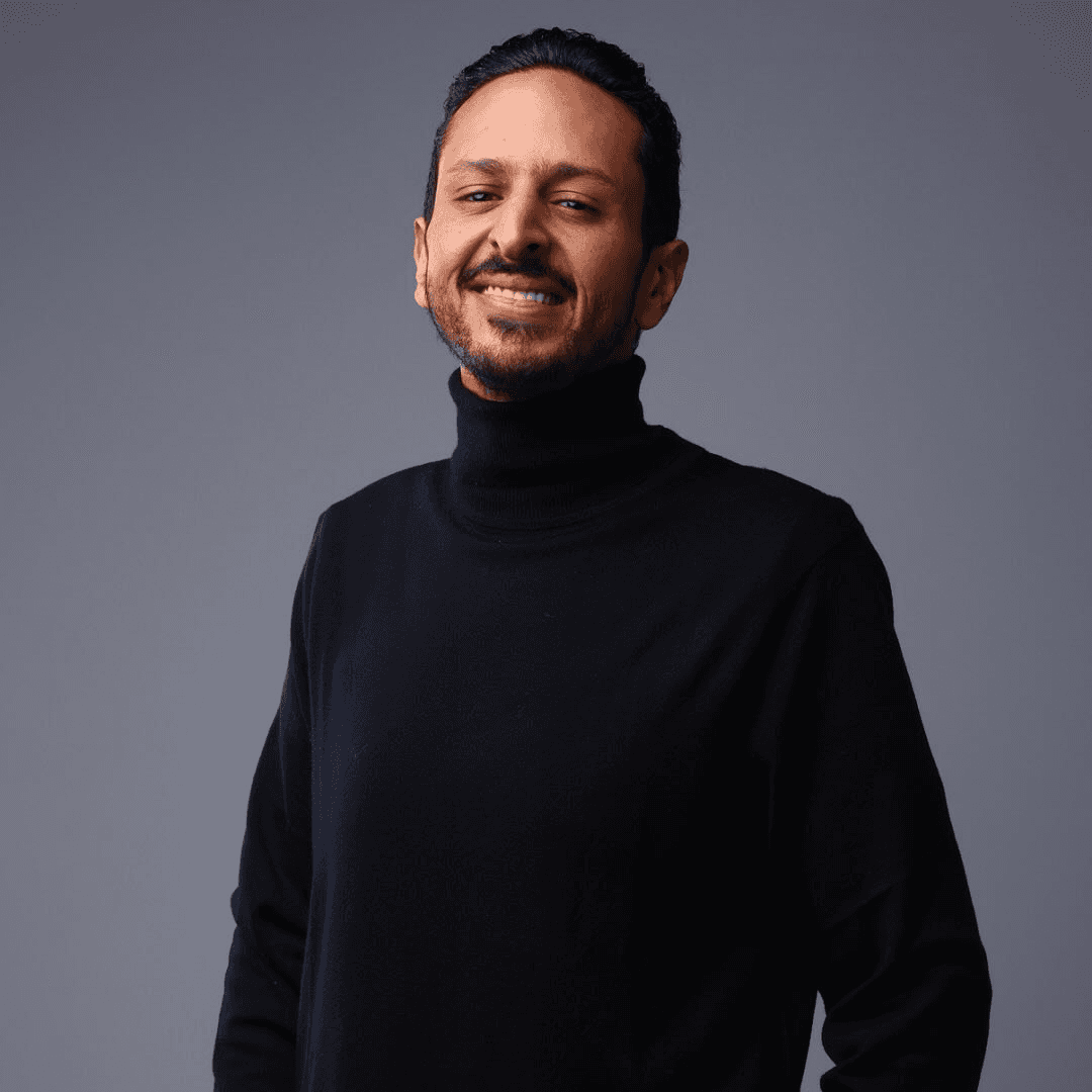 A happy customer smiling wearing orange headband