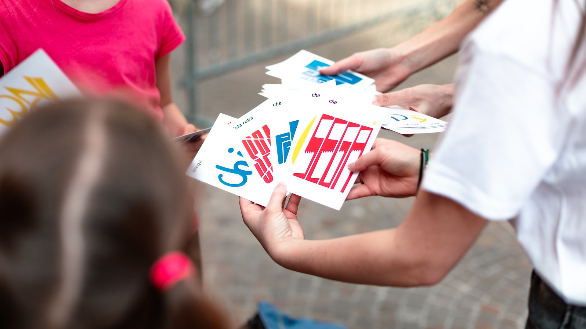 Close-up of a yellow tennis ball sitting on a green court, positioned near the white center line.