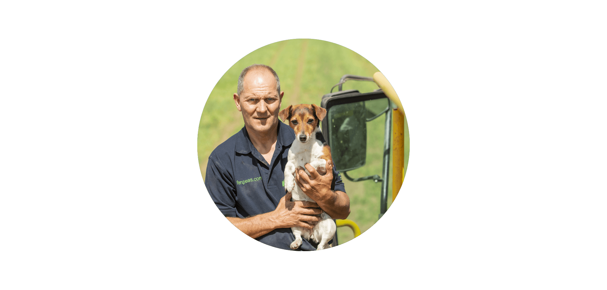 A farmer wearing a fenpeas.com polo shirt holding a Jack Russell terrier, standing in front of a yellow pea harvester in a field, displayed in a circular crop against a black background.