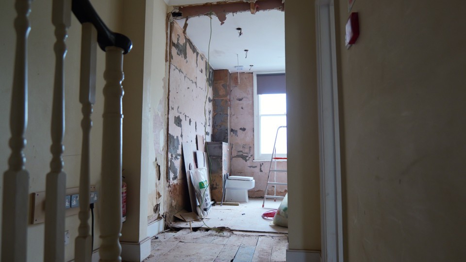 HMO refurbishment works showing stripped walls and preparation for new room layout