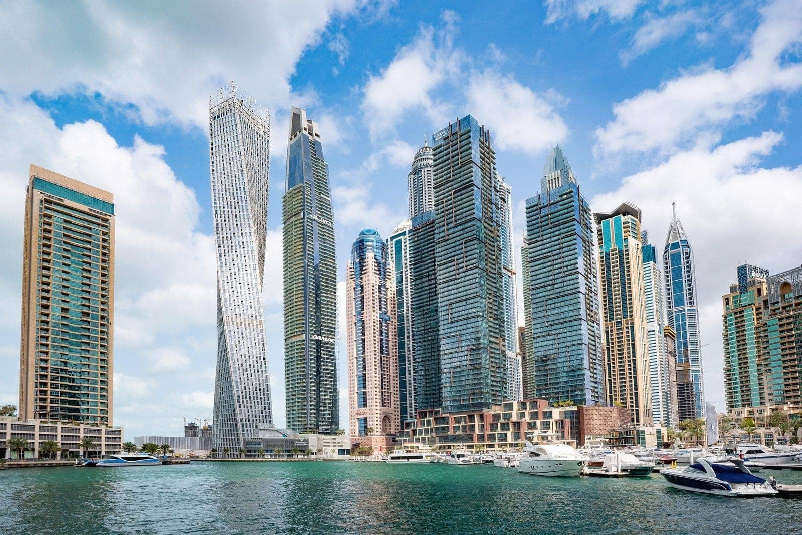 Skyline of Dubai Marina featuring modern high-rise towers, waterfront residential buildings, and luxury yachts along the marina.