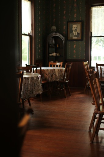 Dining room with antique furniture and portrait