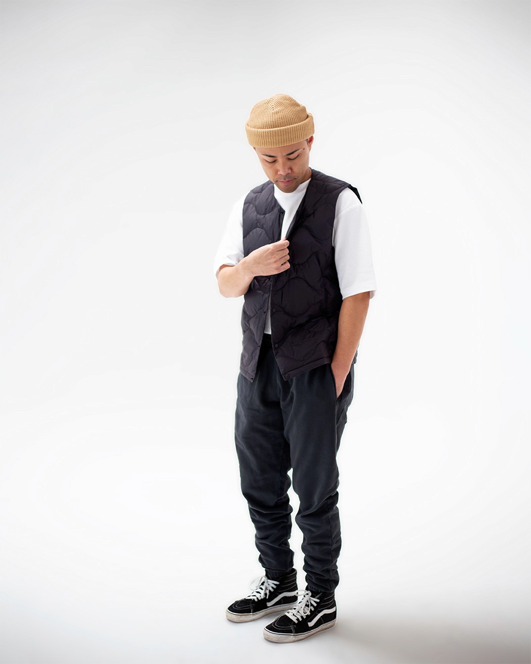 Model looking down vest