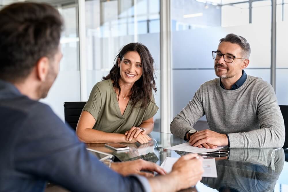Man and woman meeting another man in a busines setting