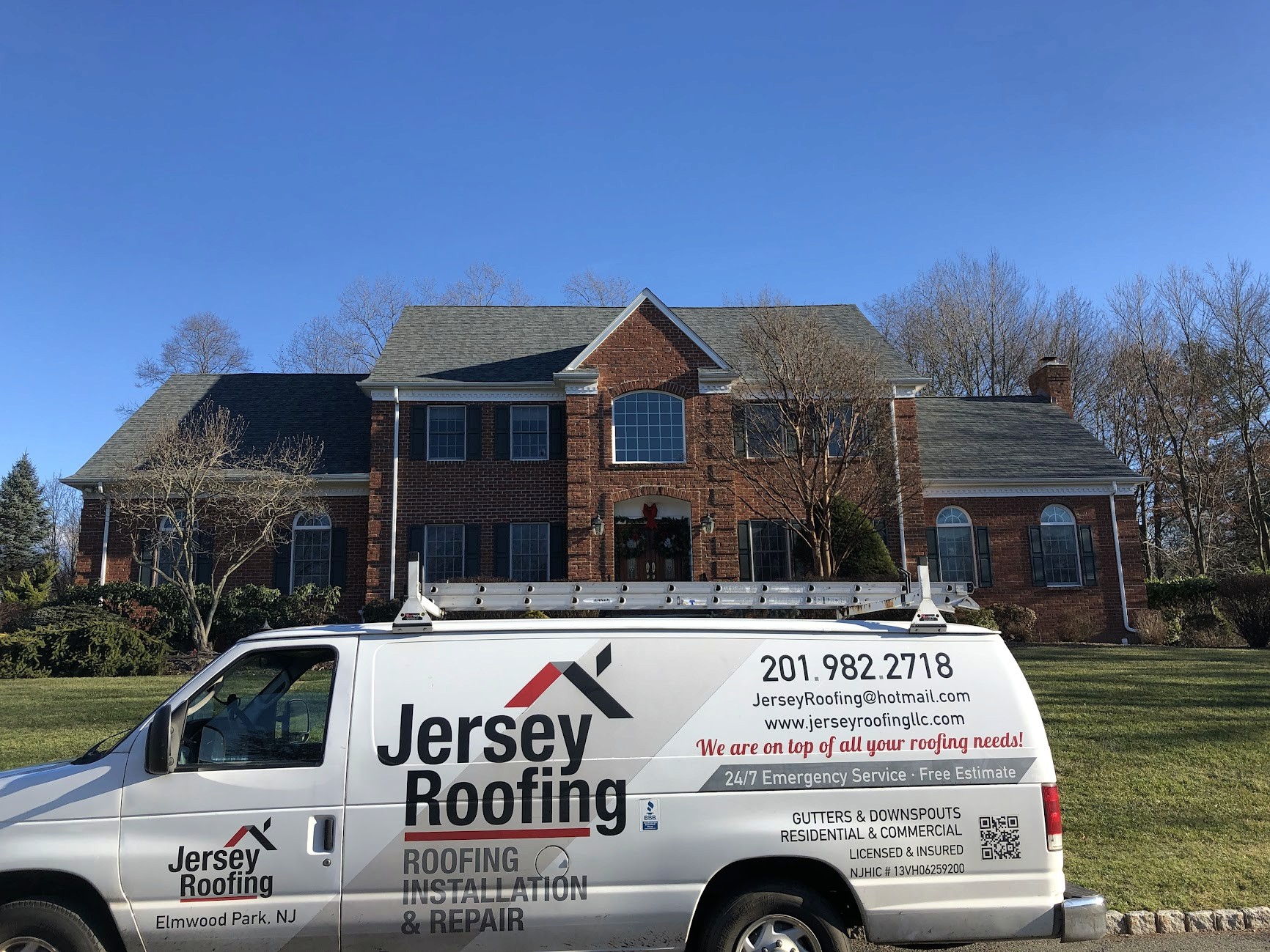 A roofing contractor parked outside a home in Paterson, NJ