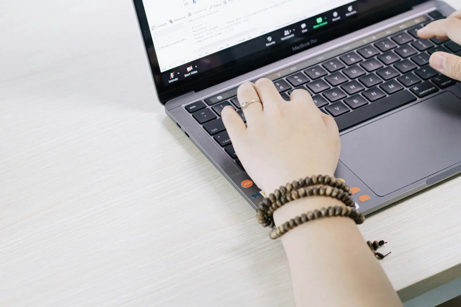 Close-up of someone using a laptop to review records and details online