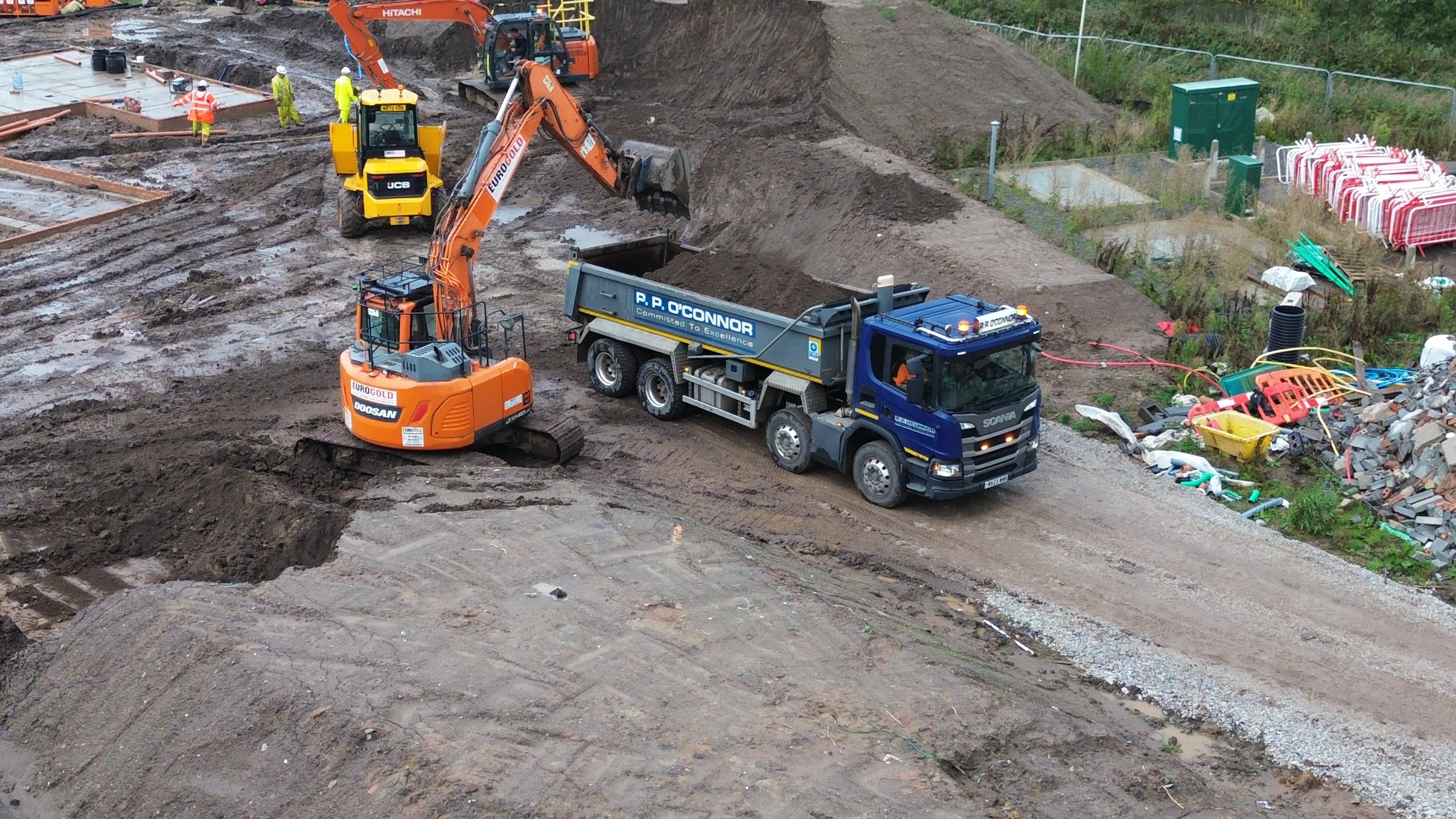 Excavator and tipper truck moving subsoil