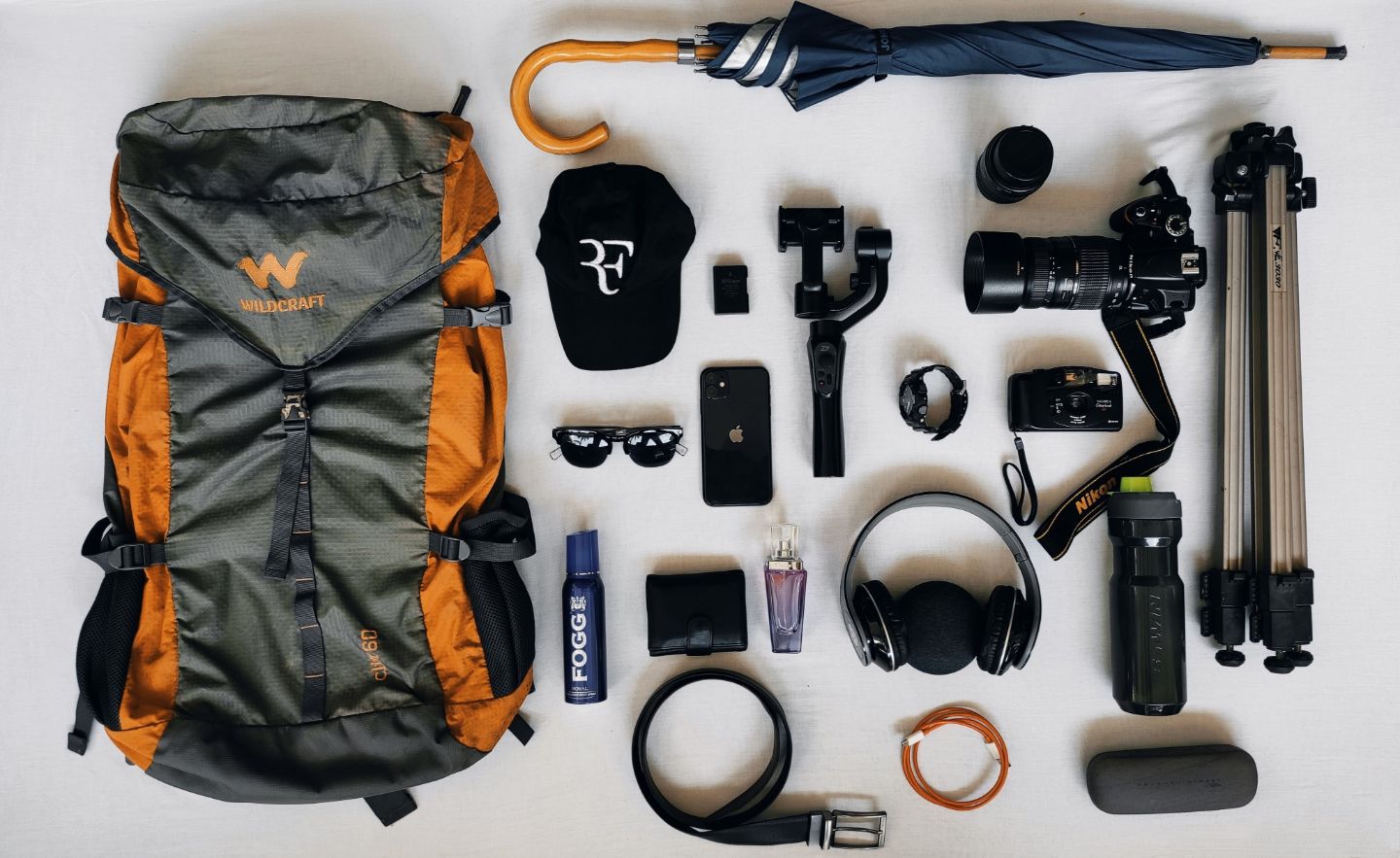 Travel essentials including a map of Iceland, backpack, camera, notebook, and hat for planning an Iceland trip.