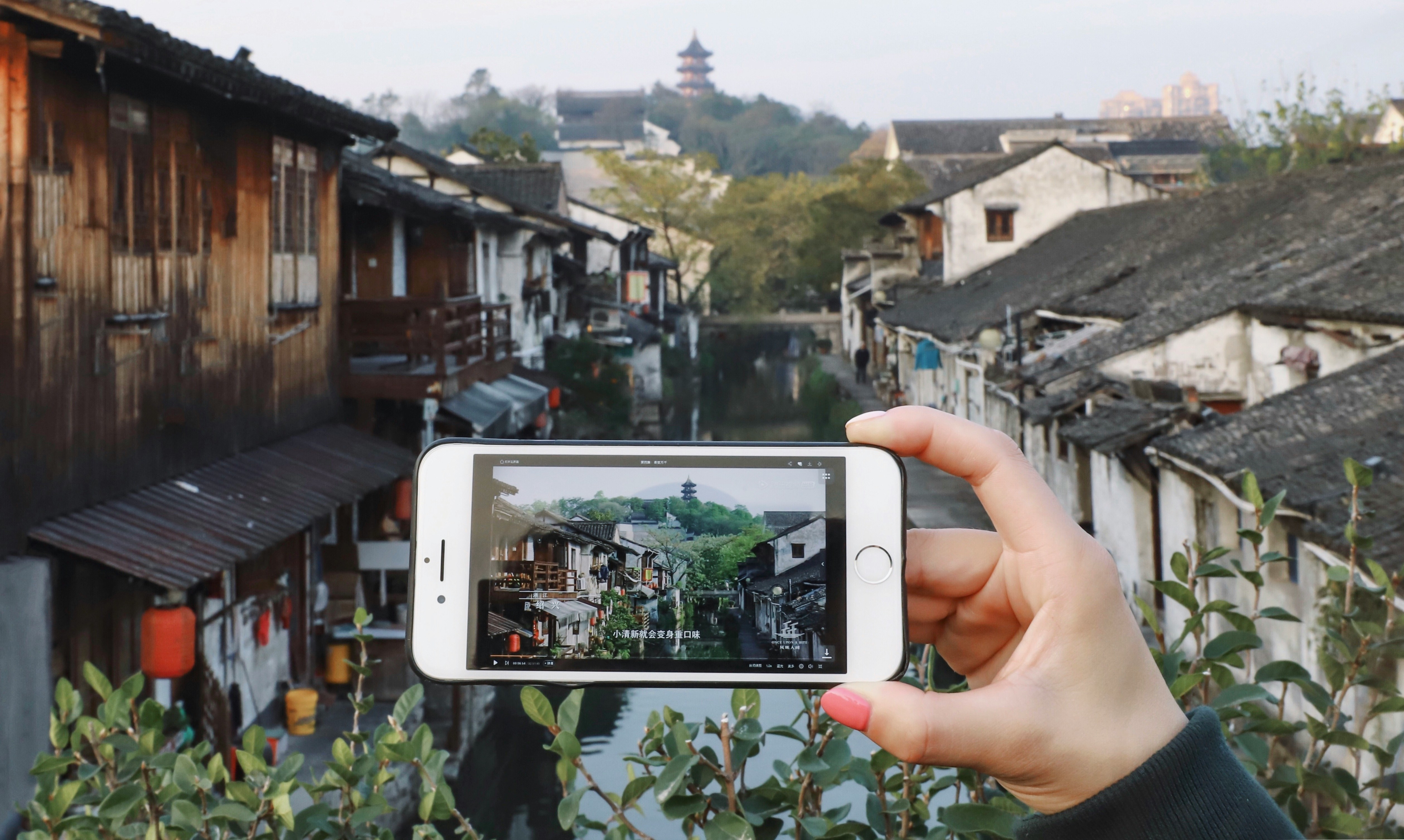 smartphone taking a photo of old Japaese townhouses