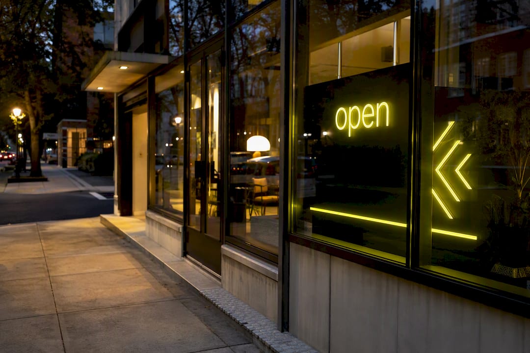 Active business storefront at twilight with neon signage