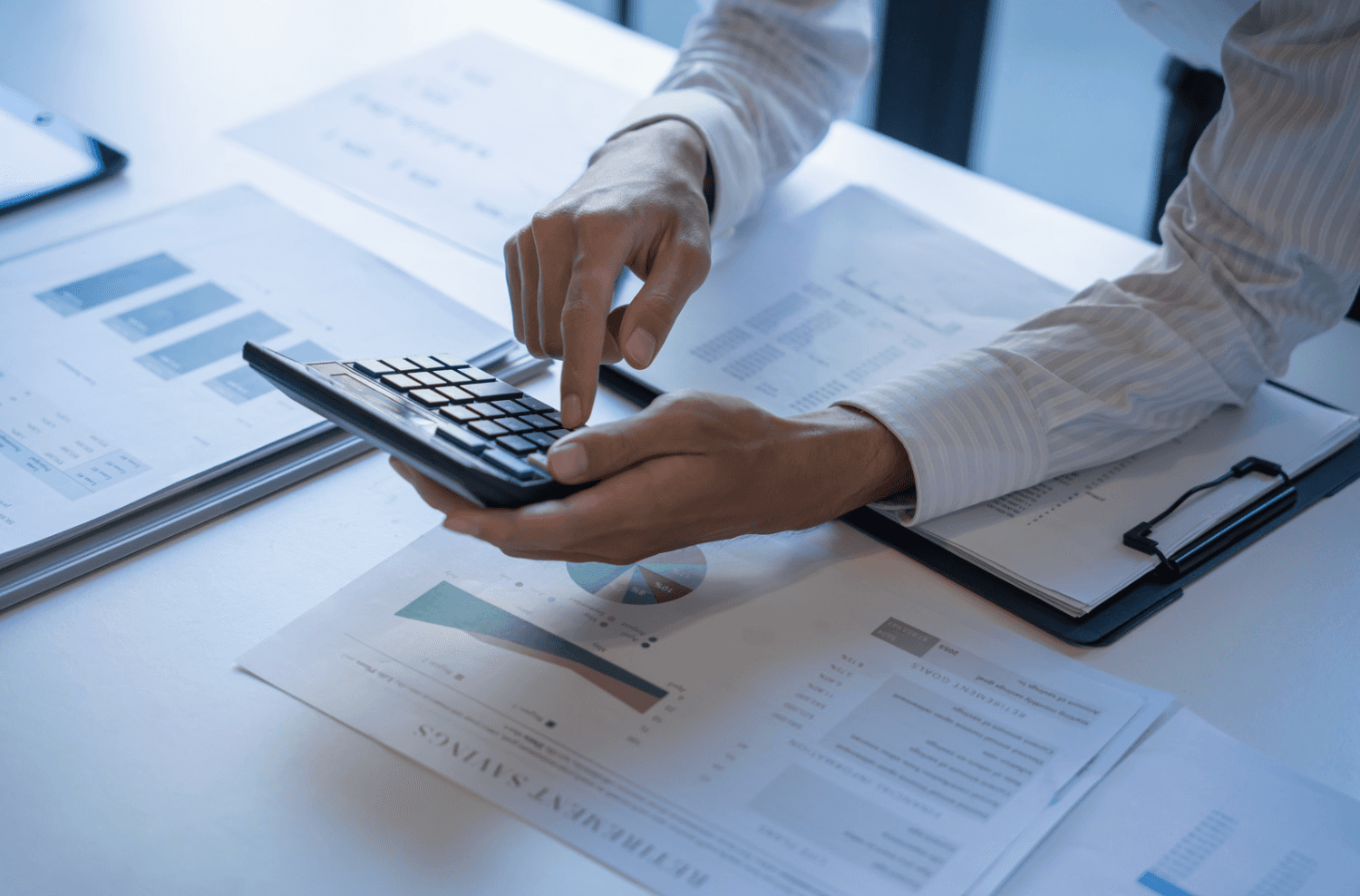 Professional reviewing marketing data and calculating metrics, symbolizing goal setting and campaign restructuring for seasonal Amazon PPC strategy.