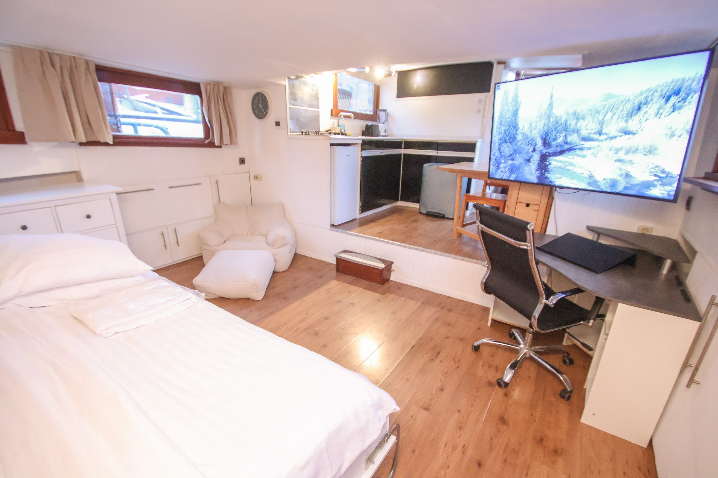 Grey marble bathroom with round mirror and floating sink