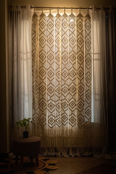 Handmade macrame curtain panel with diamond geometric pattern and fringe