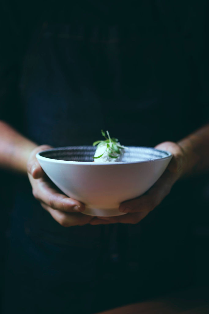 Woman with red hair covering mouth with hair