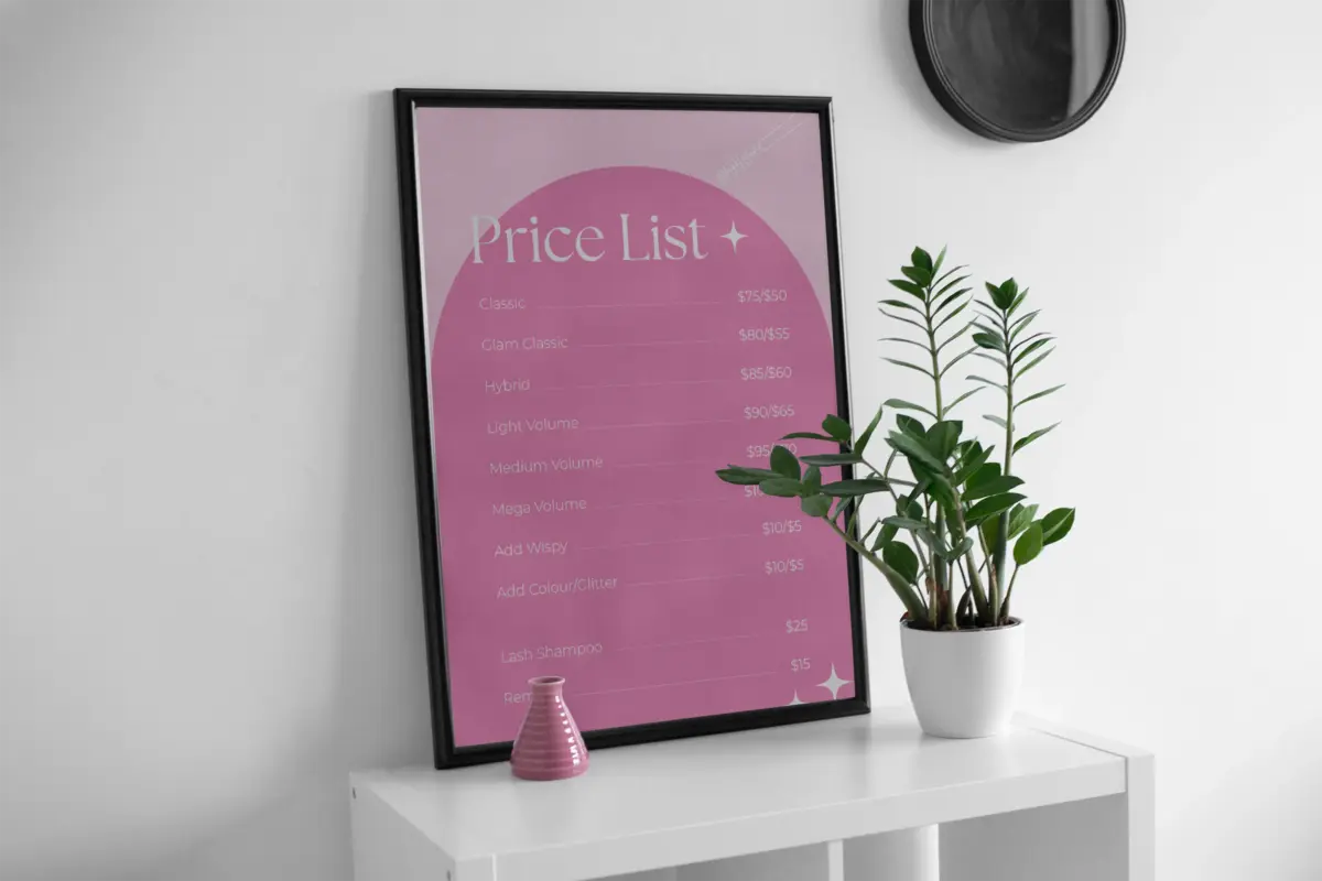 Framed pink Price List poster on a white shelf beside a plant