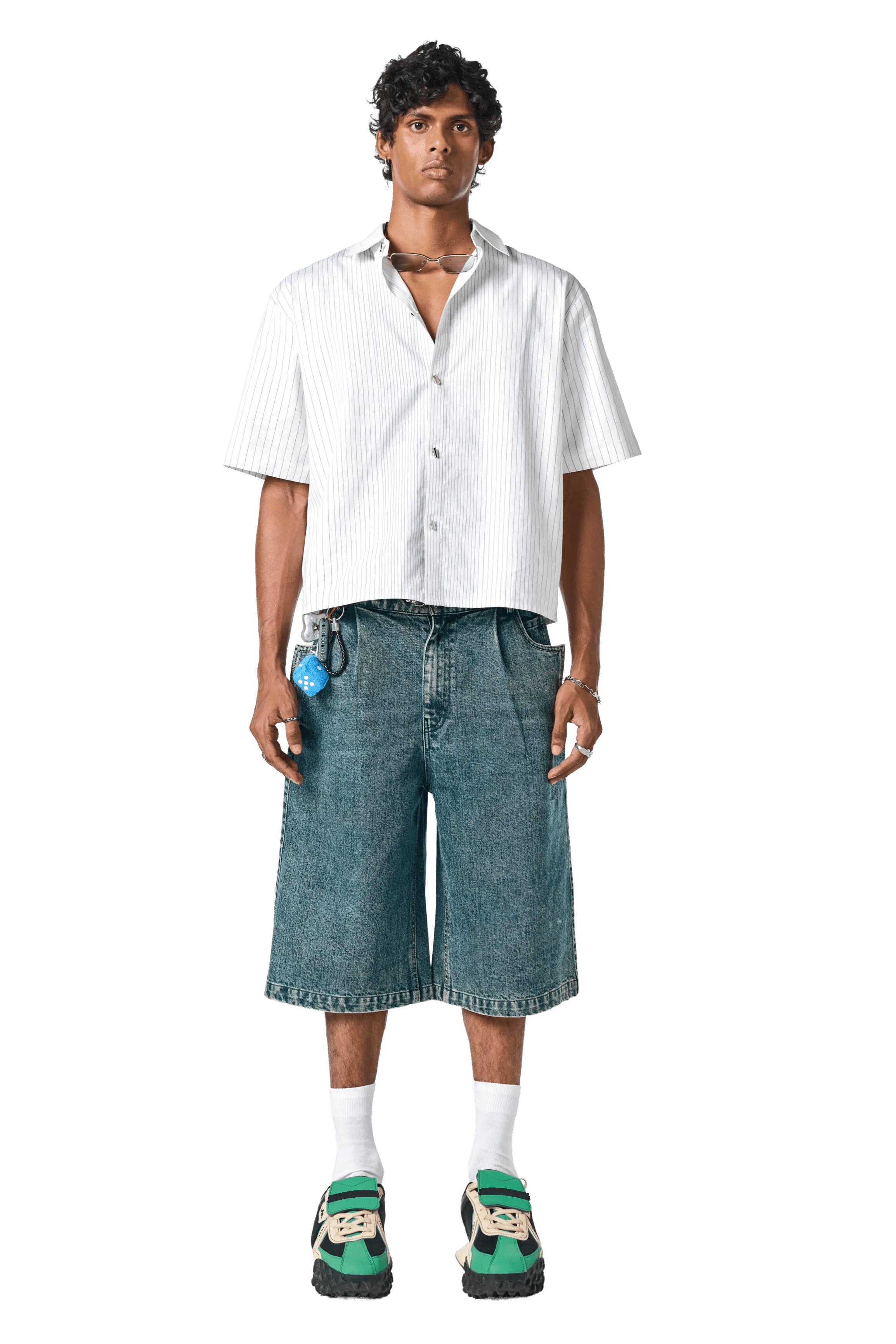 Man wearing a white shirt and denim shorts on a white background
