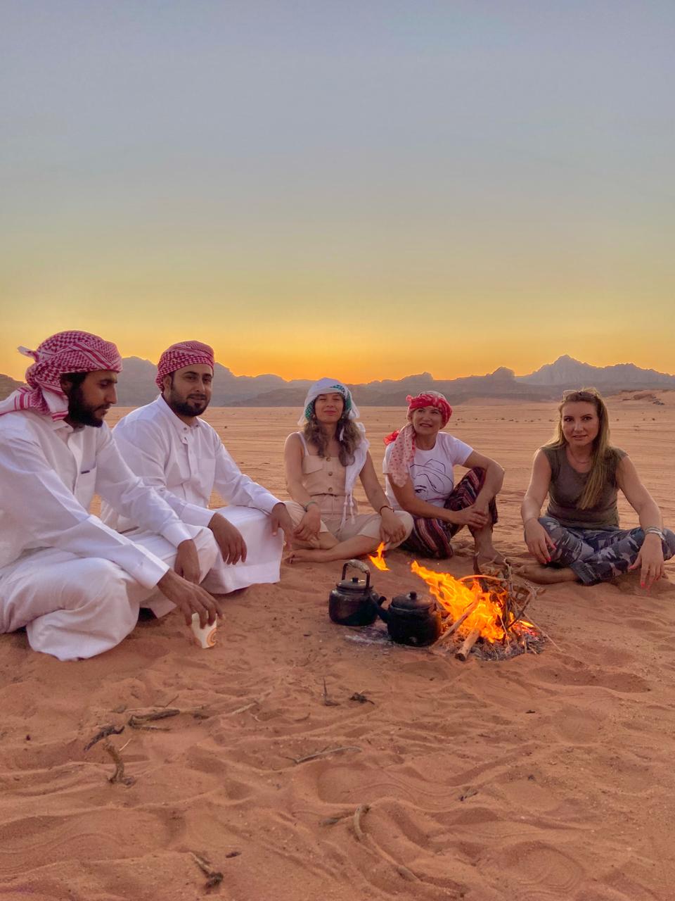 Bedouin guides with our guests during a sunset in the wadi rum desert, jordan
