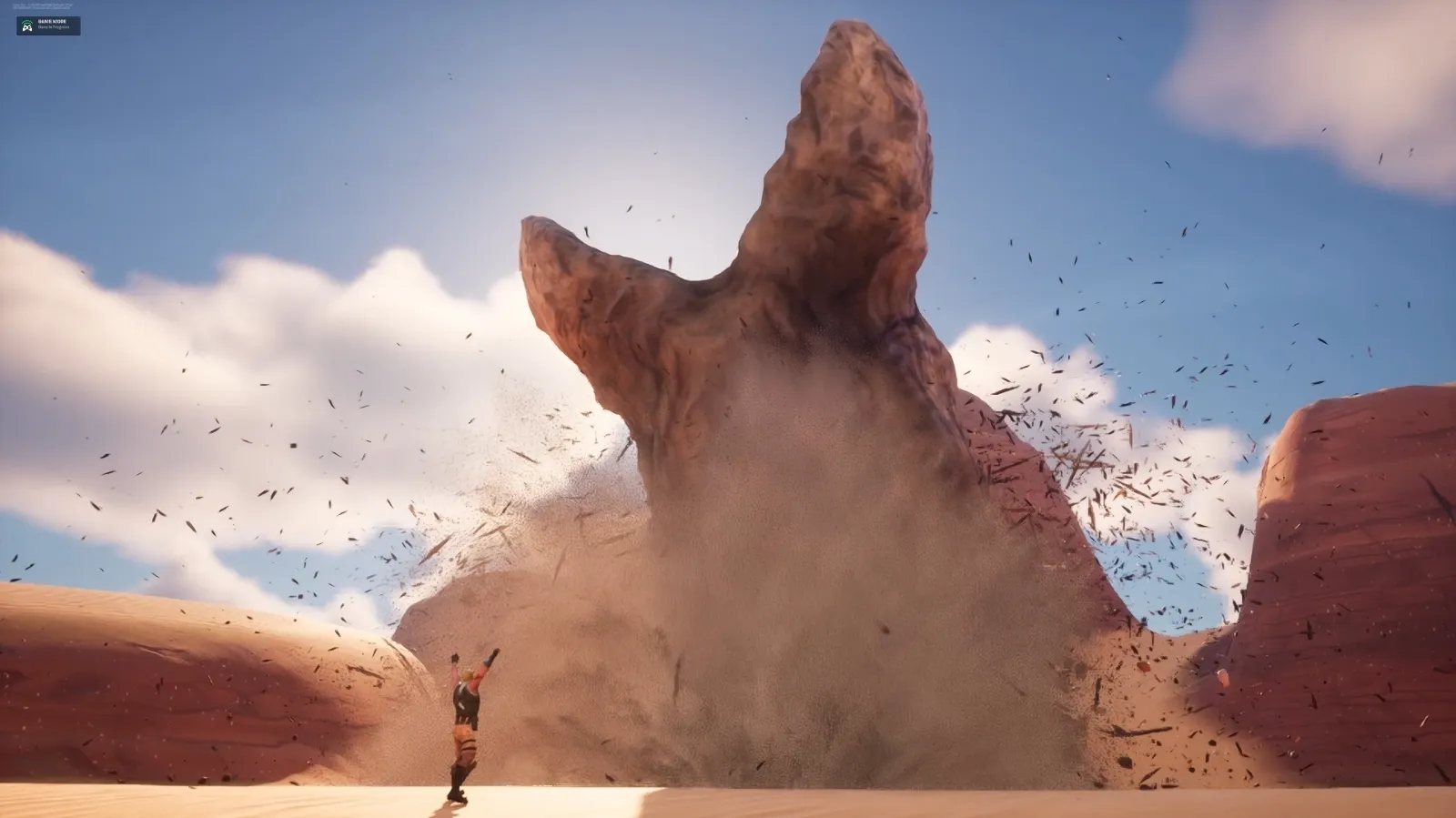 A person raises their arms near a massive, sandworm blasting blasting up through a rock formation in a desert landscape under a blue sky with scattered clouds.