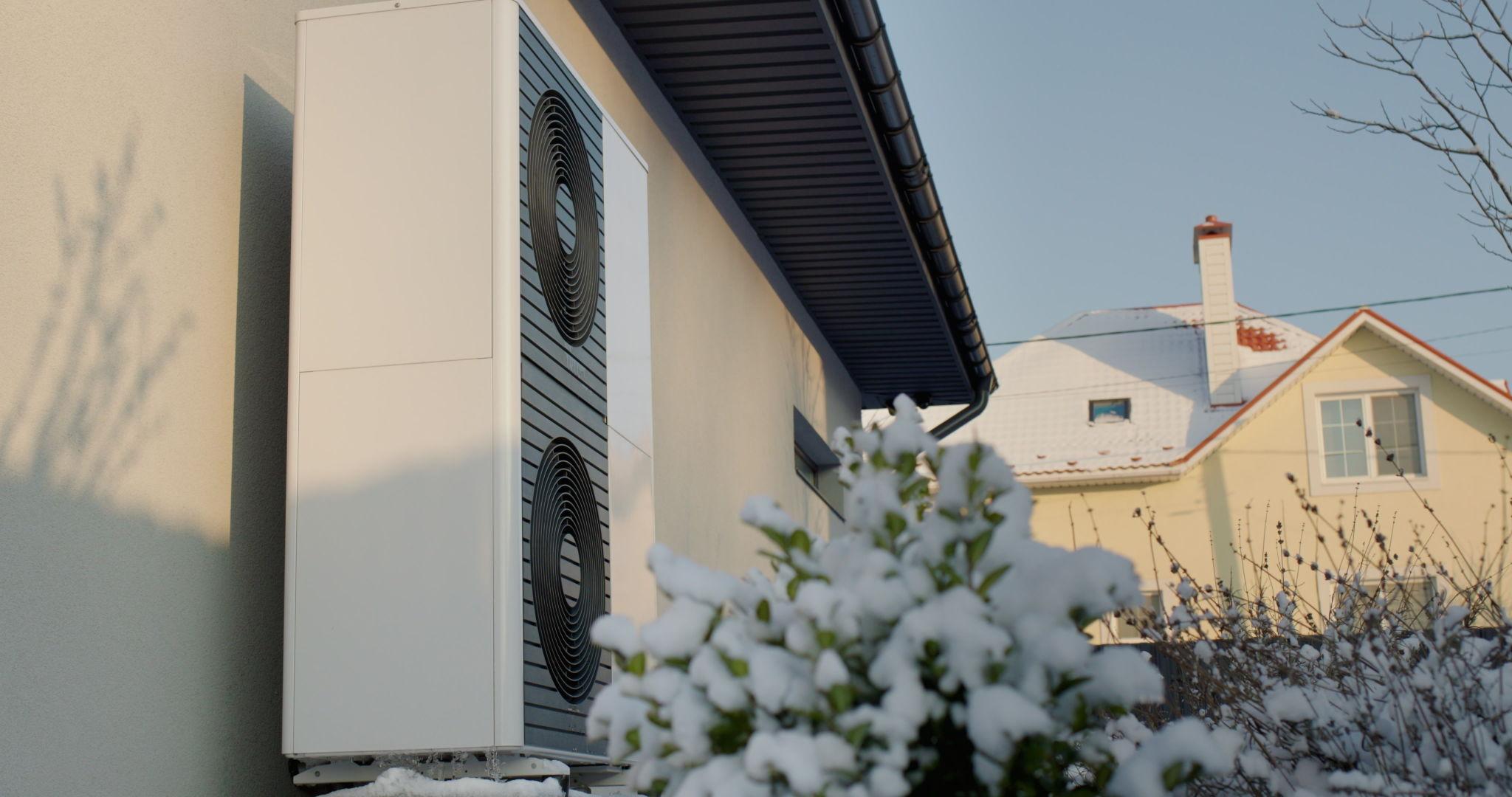 Air source heat pump outdoor unit running overnight outside a UK home in cold winter temperatures showing normal continuous operation