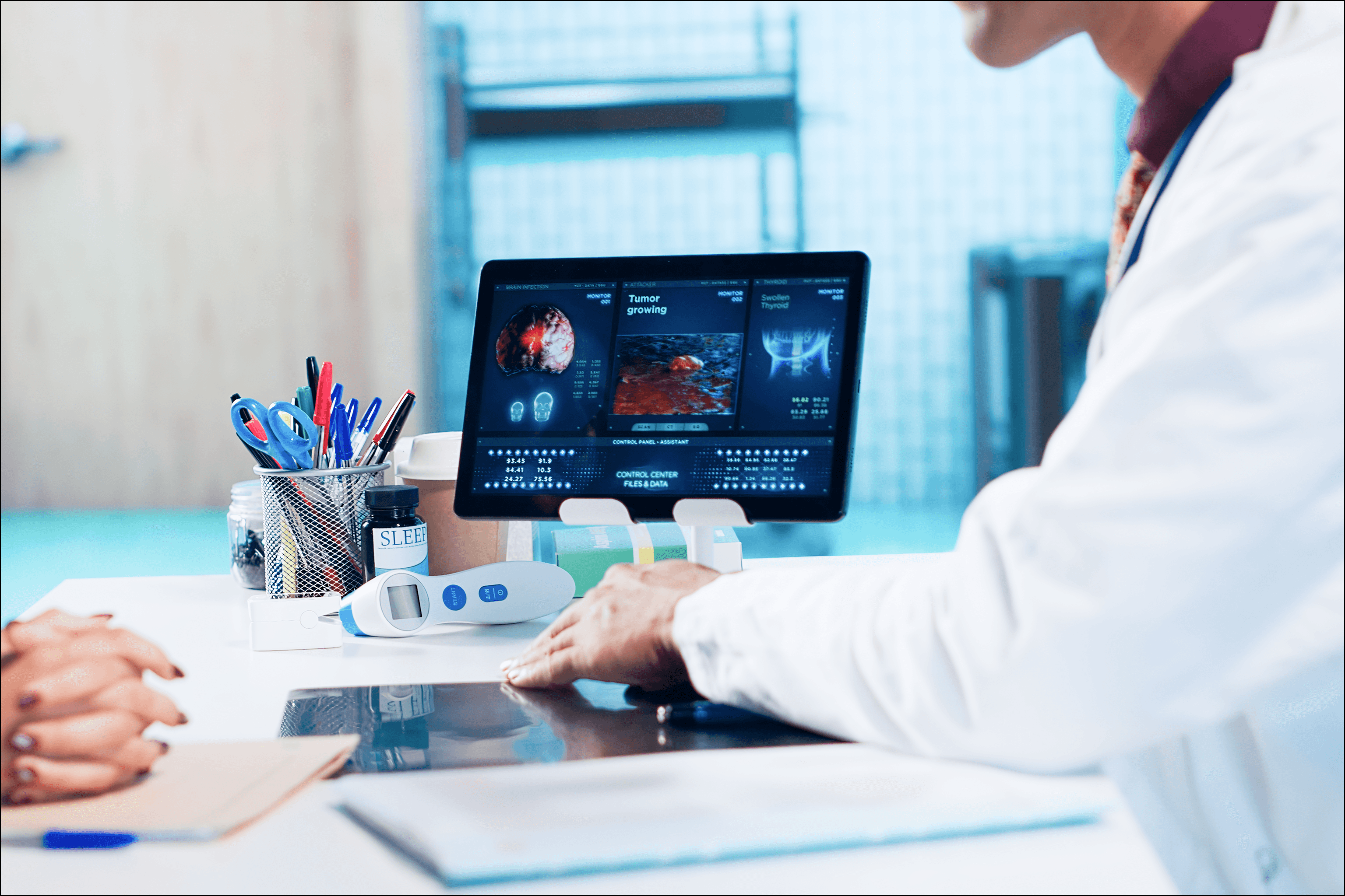 A clinician reviewing digital diagnostic images and patient data on a tablet, illustrating different types of healthcare information systems used in clinical decision-making.