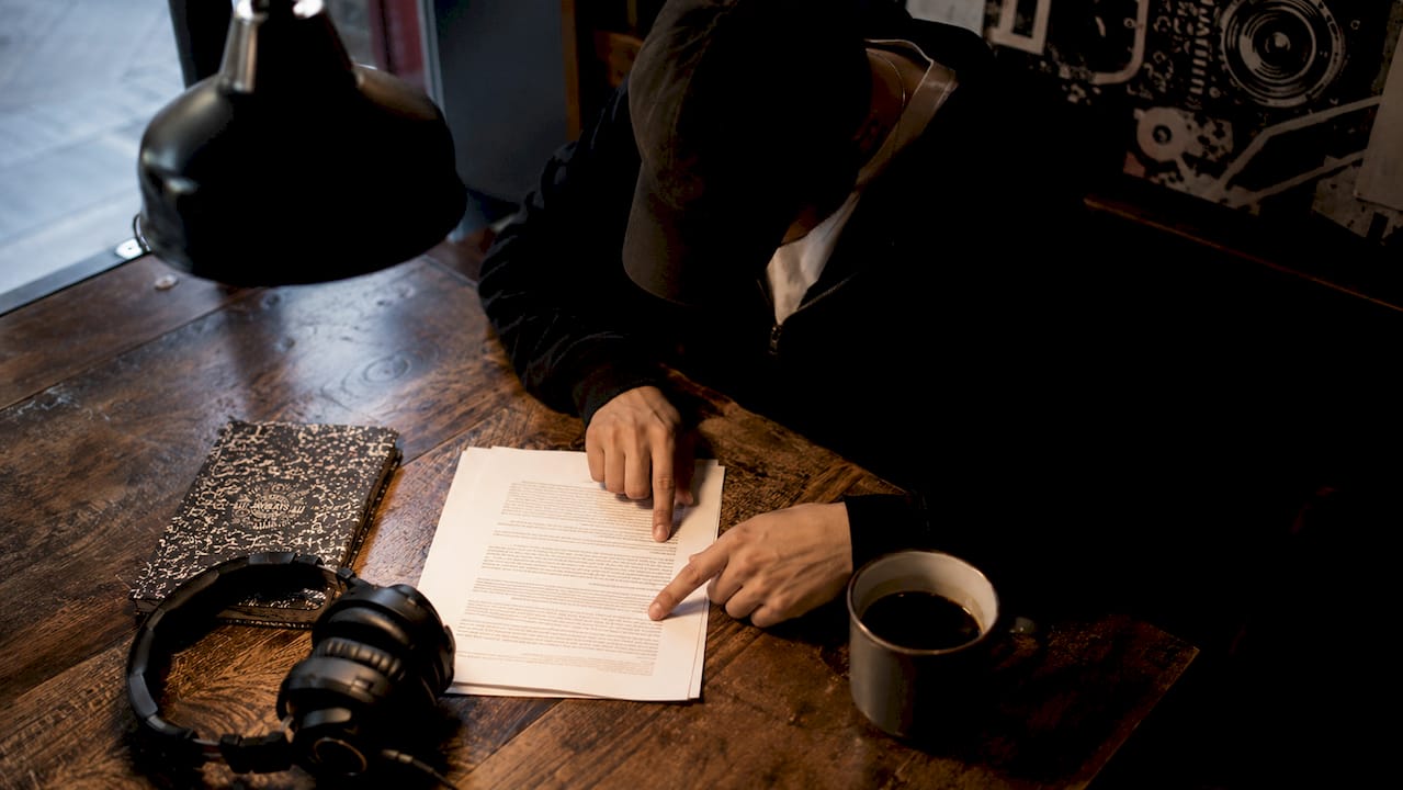 Hands reviewing a beat lease contract