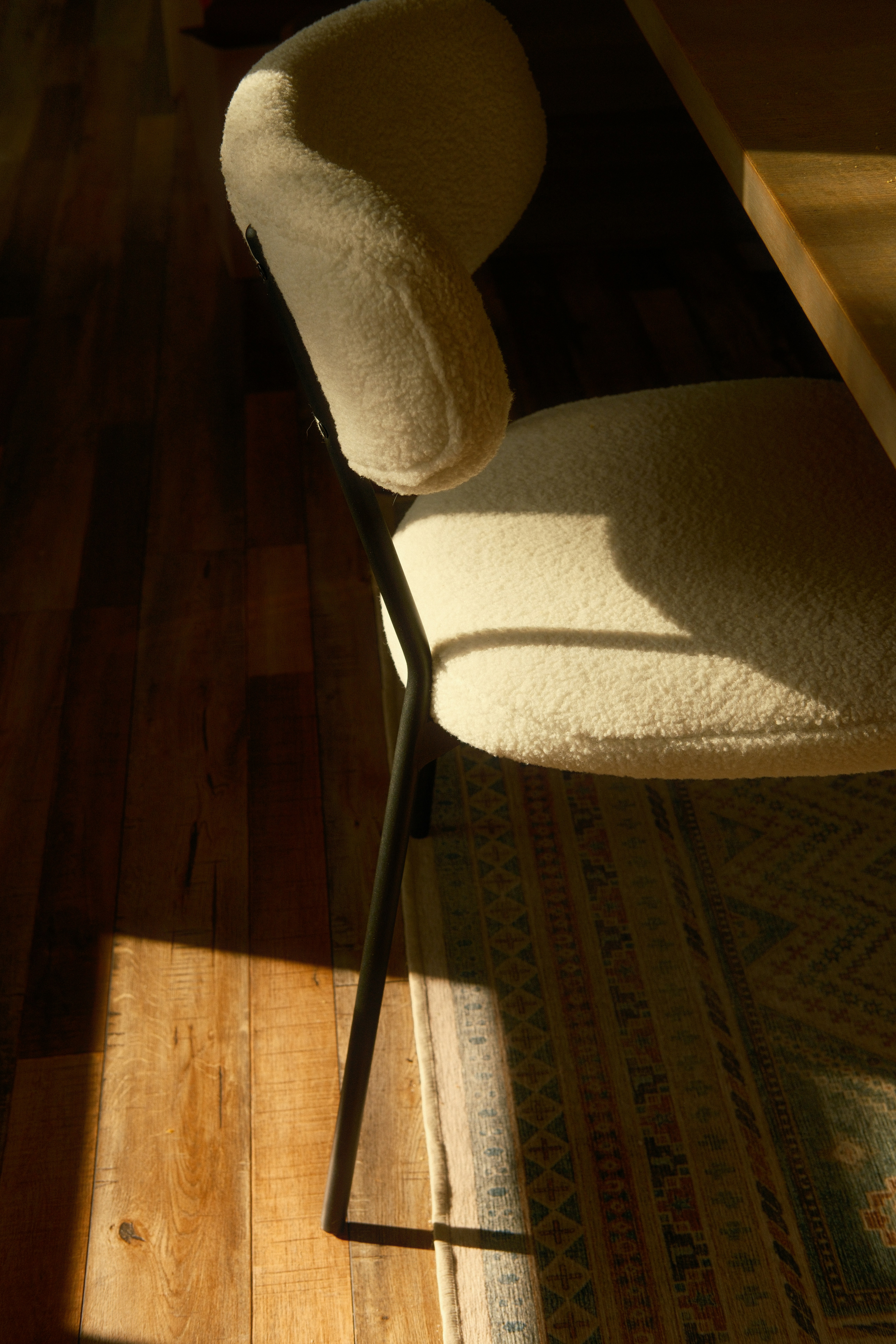 A textured cream chair in warm sunlight