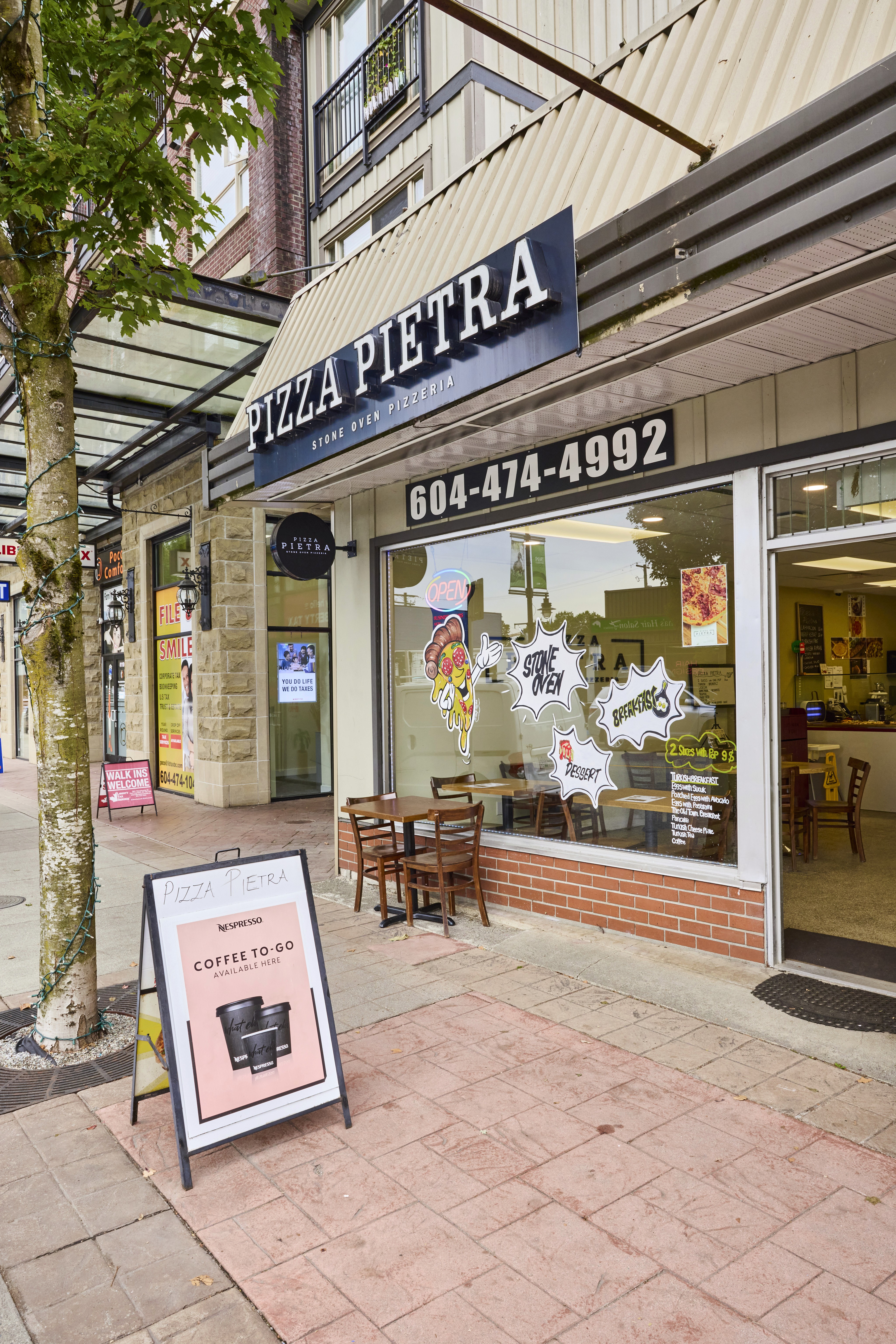 Close-up of a male runner in a red jersey and black shorts, wearing a smartwatch, mid-stride during a race.