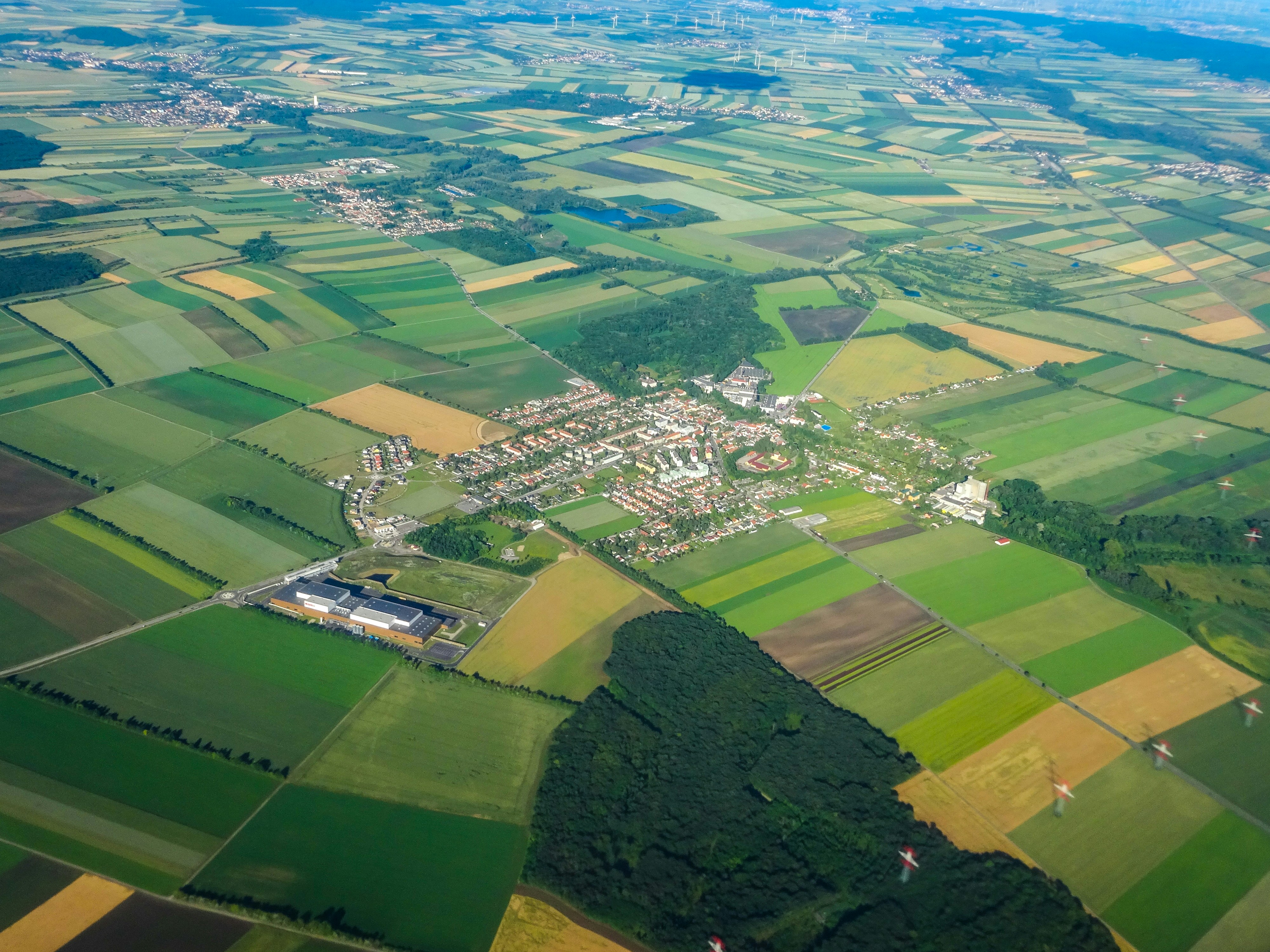 Aerial view of agricultural fields surrounding a small town.