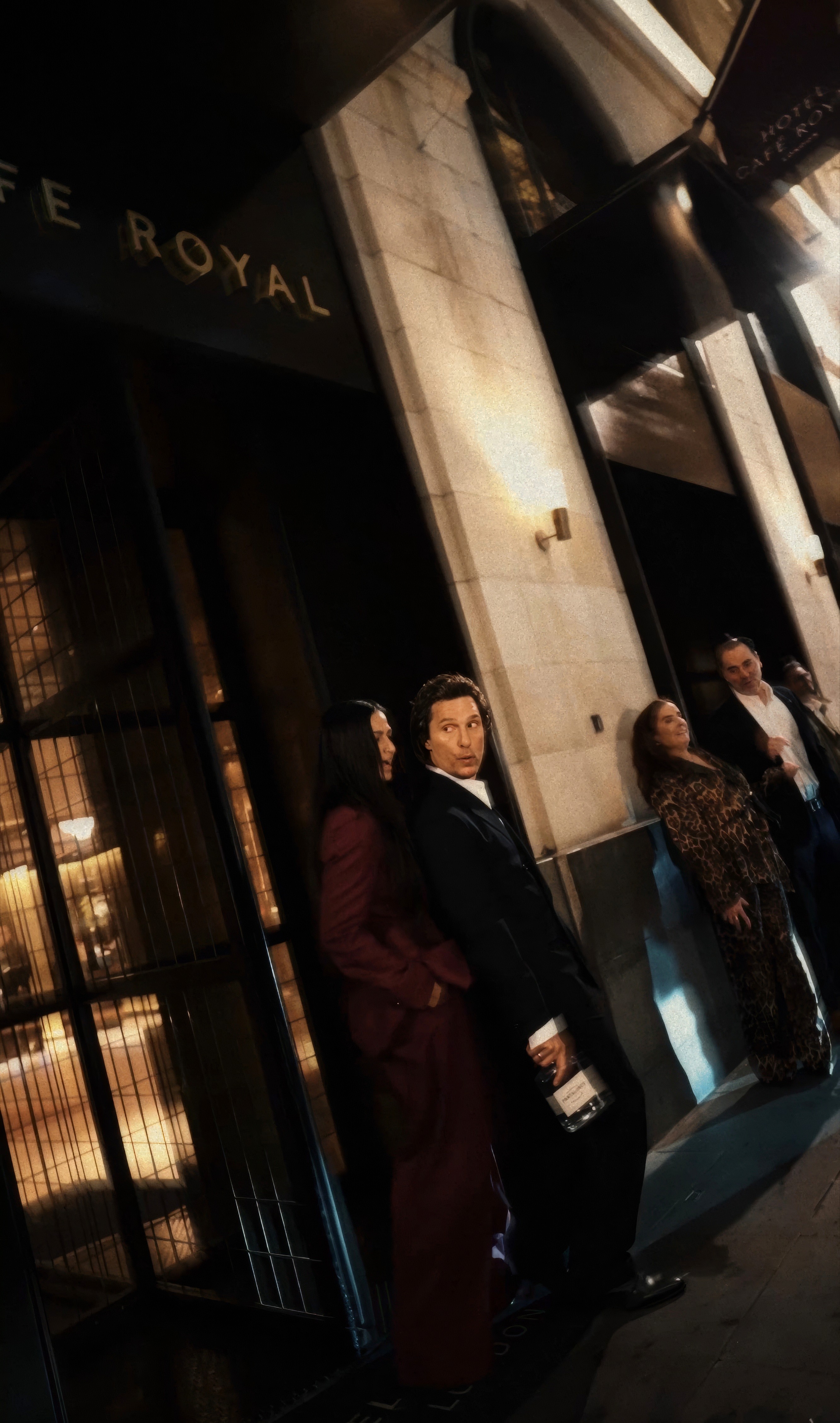 Bride in white dress walking on street, man in background